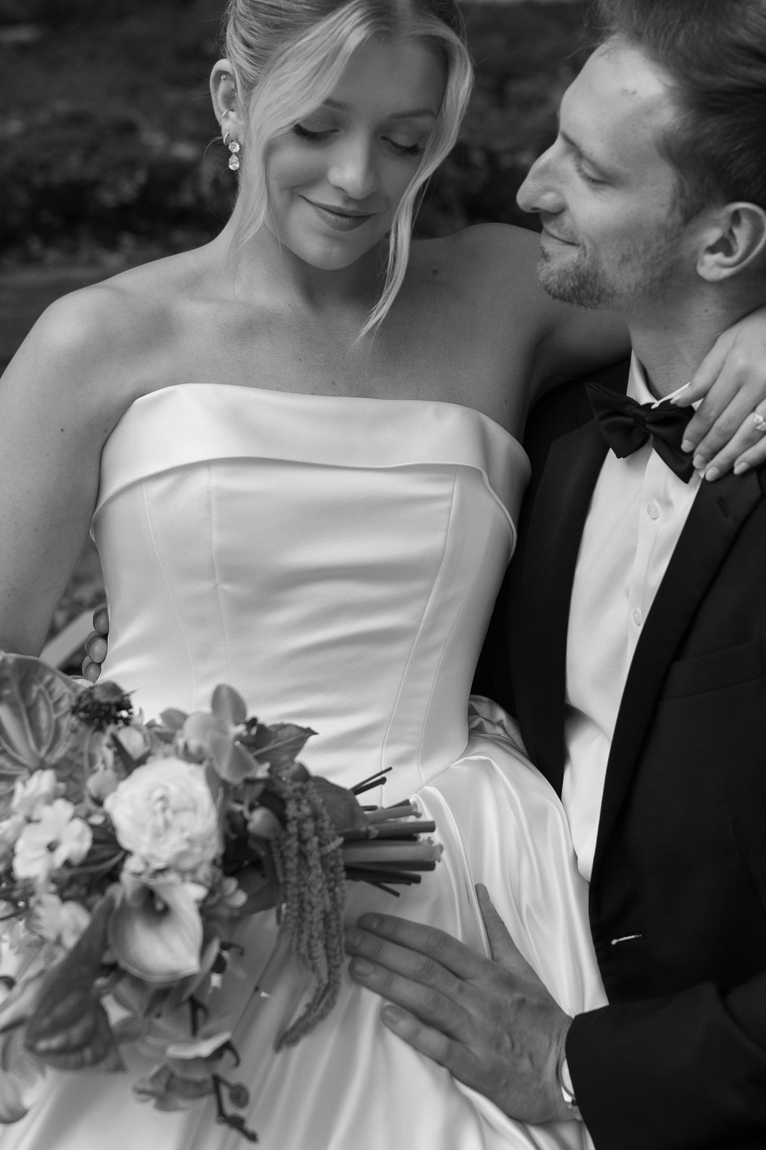 Black and white wedding photo series showing intimate moments between newlyweds with bridal bouquet details.