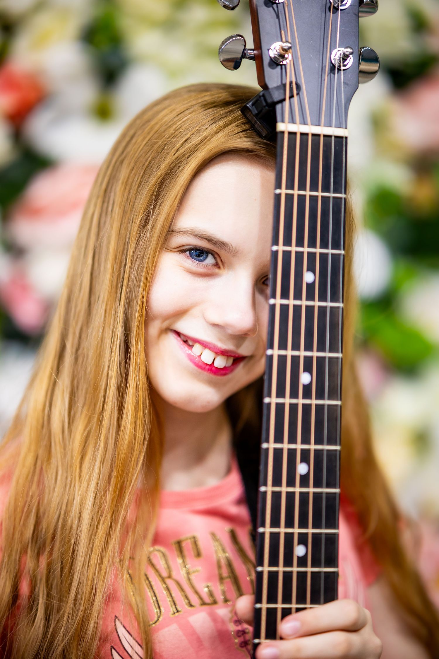 Close-up shots of someone posing with an acoustic guitar against a floral background.