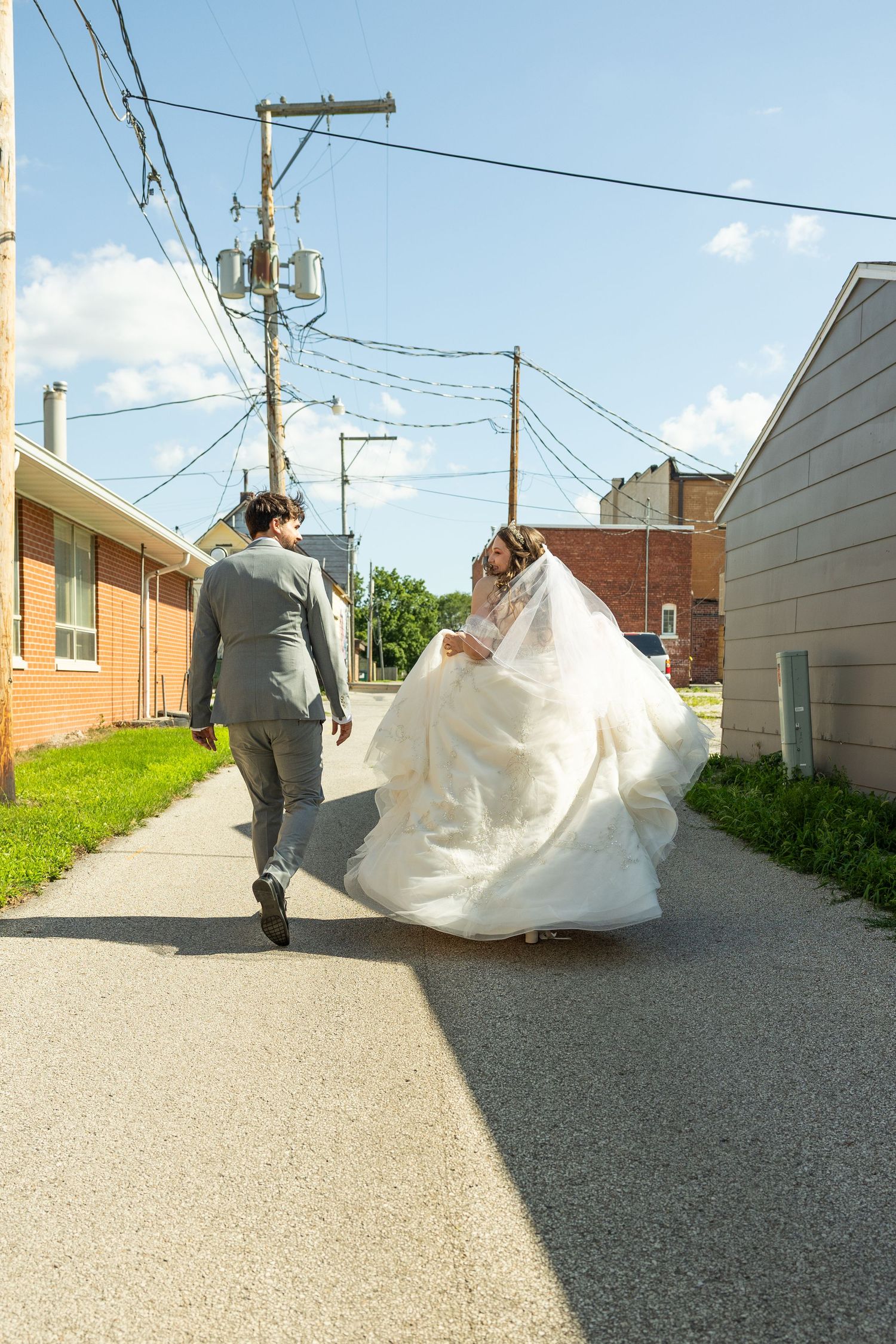 A wedding photo sequence showing the bride's dress flowing gracefully in a breeze along a gravel path.