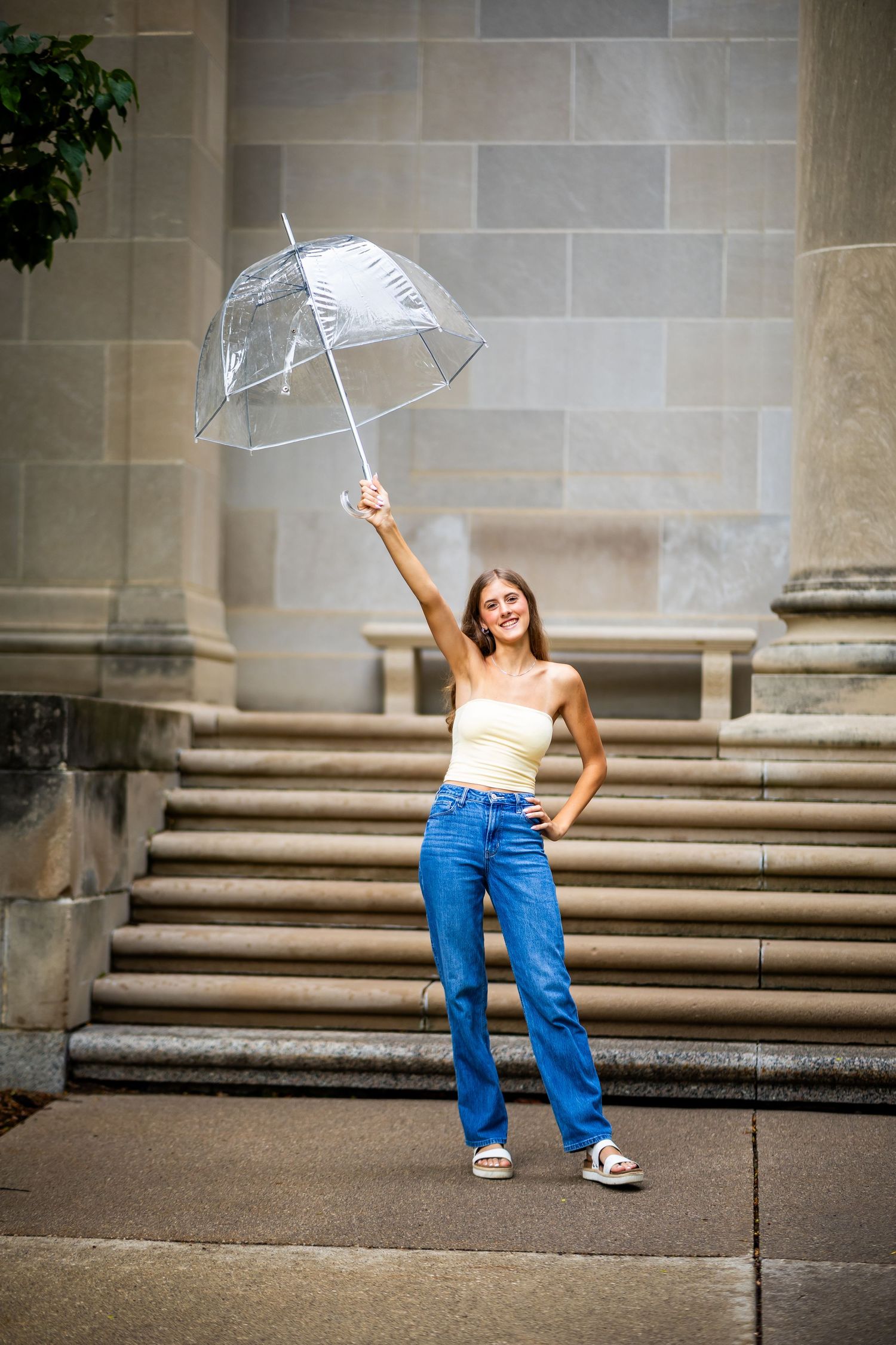 Playful sequence of throwing and catching a white umbrella on stone steps.