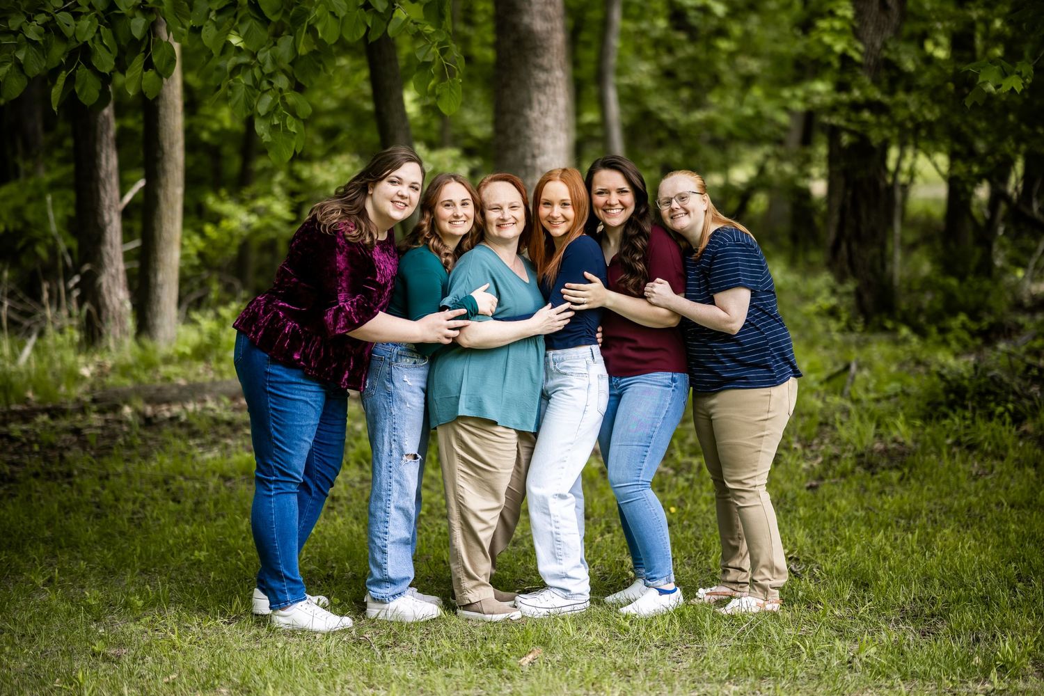 Group photo session in a casual outdoor setting with matching denim outfits.