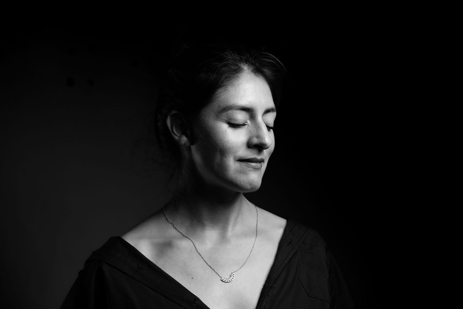 Black and white portrait series showing contemplative poses in dramatic lighting.