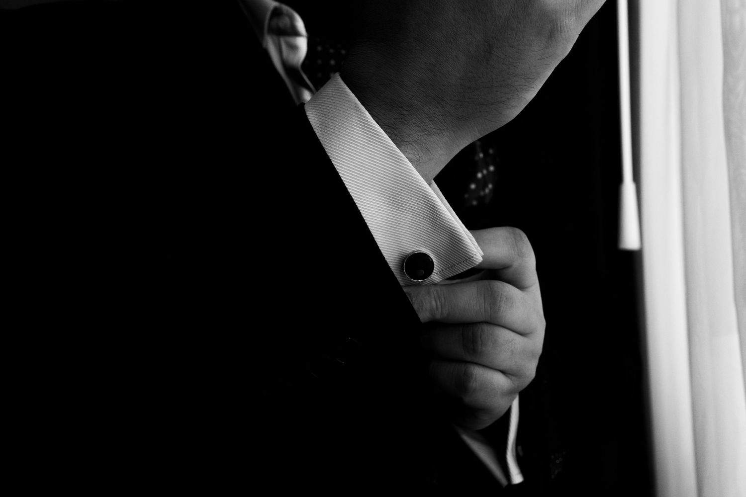 A silhouetted figure in dark lighting holds a smartphone or mobile device, creating a dramatic contrast against a bright background.