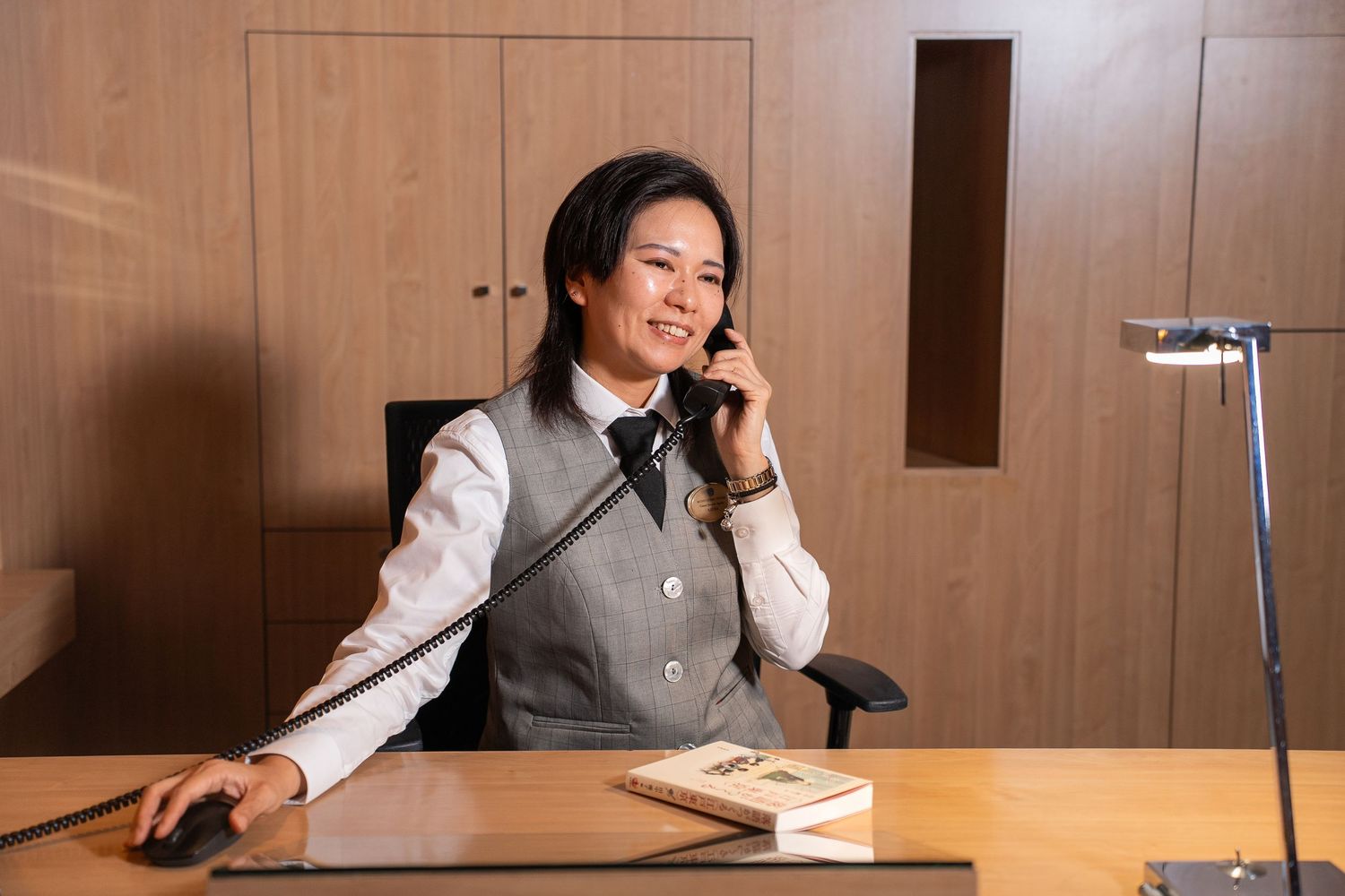 Office interior with wooden walls and desk showing professional work environment.