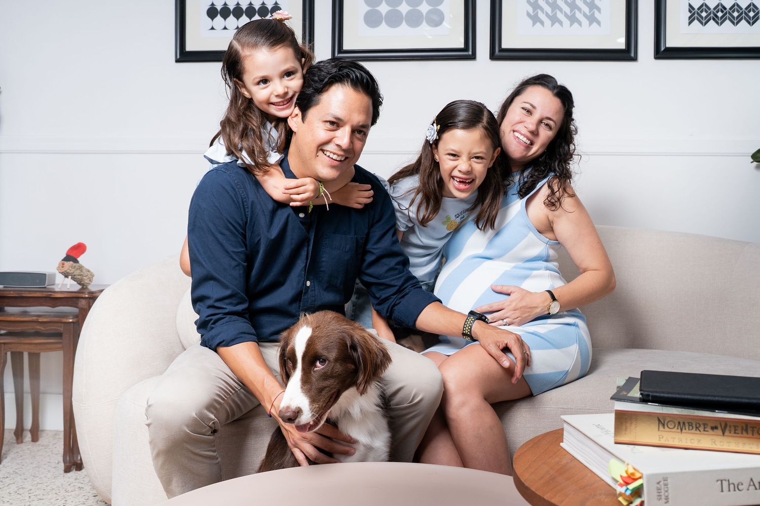 Family photo session with geometric artwork displayed on white walls.