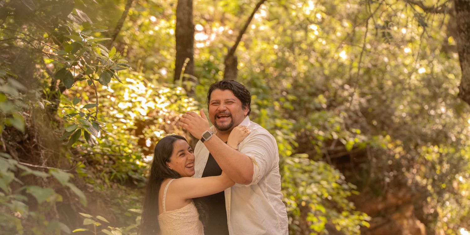 A couple performs dance steps together in a natural outdoor setting.