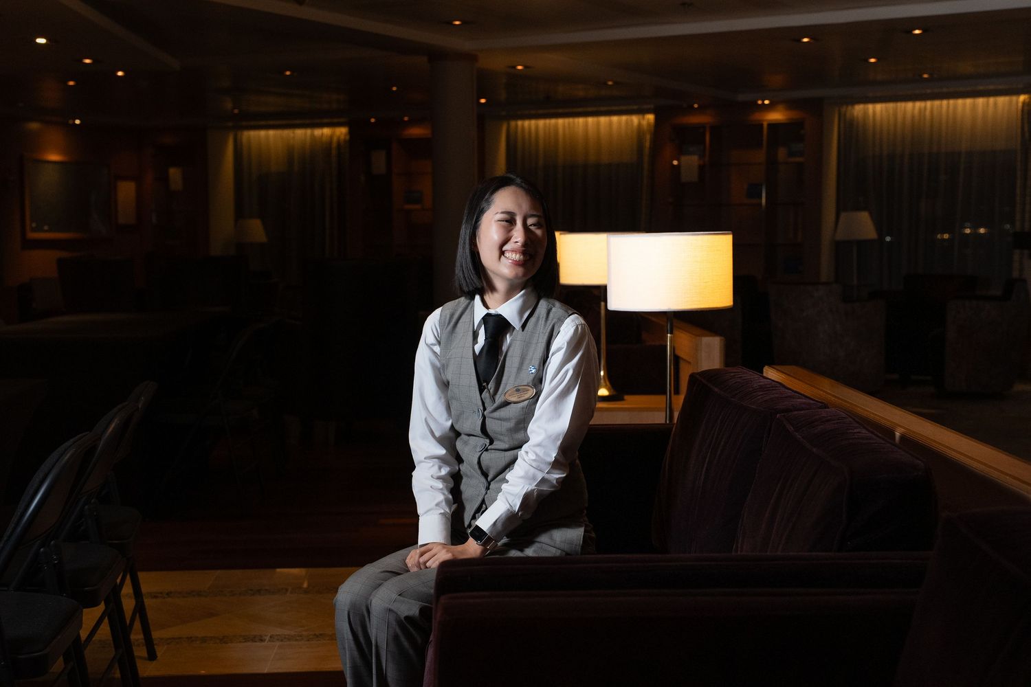 Interior of an elegant hotel lobby with warm lighting and modern furnishings.