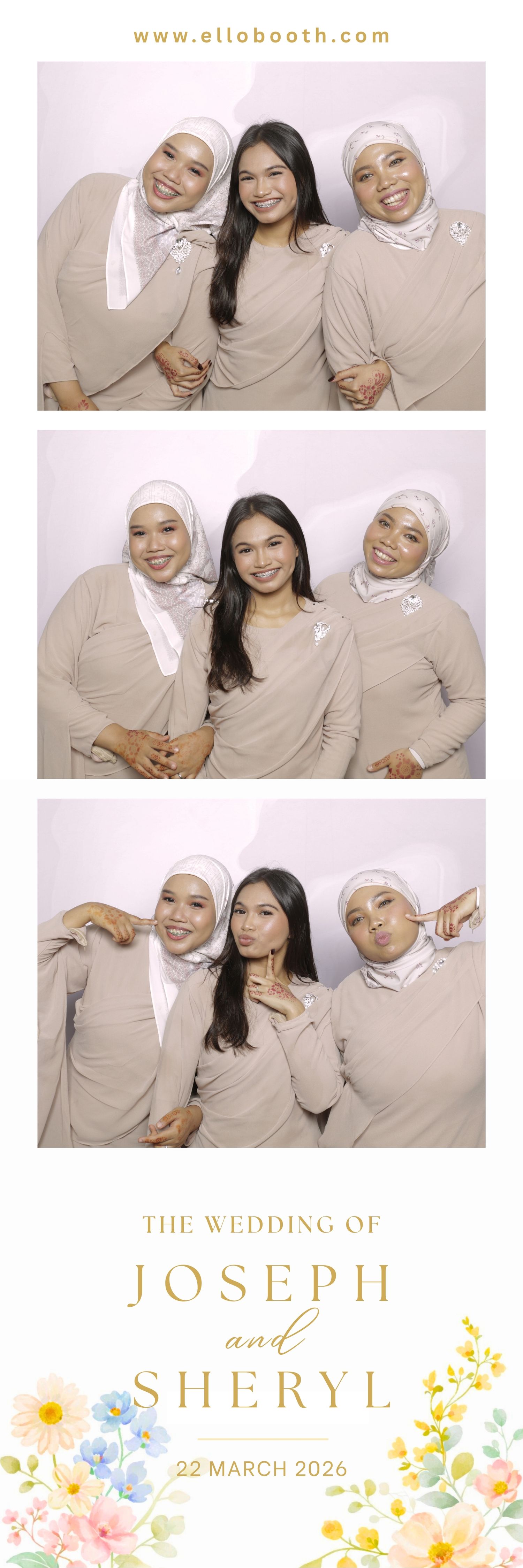 Three women in matching outfits and white headscarves pose joyfully in a photo booth at a wedding. They express happiness and camaraderie.