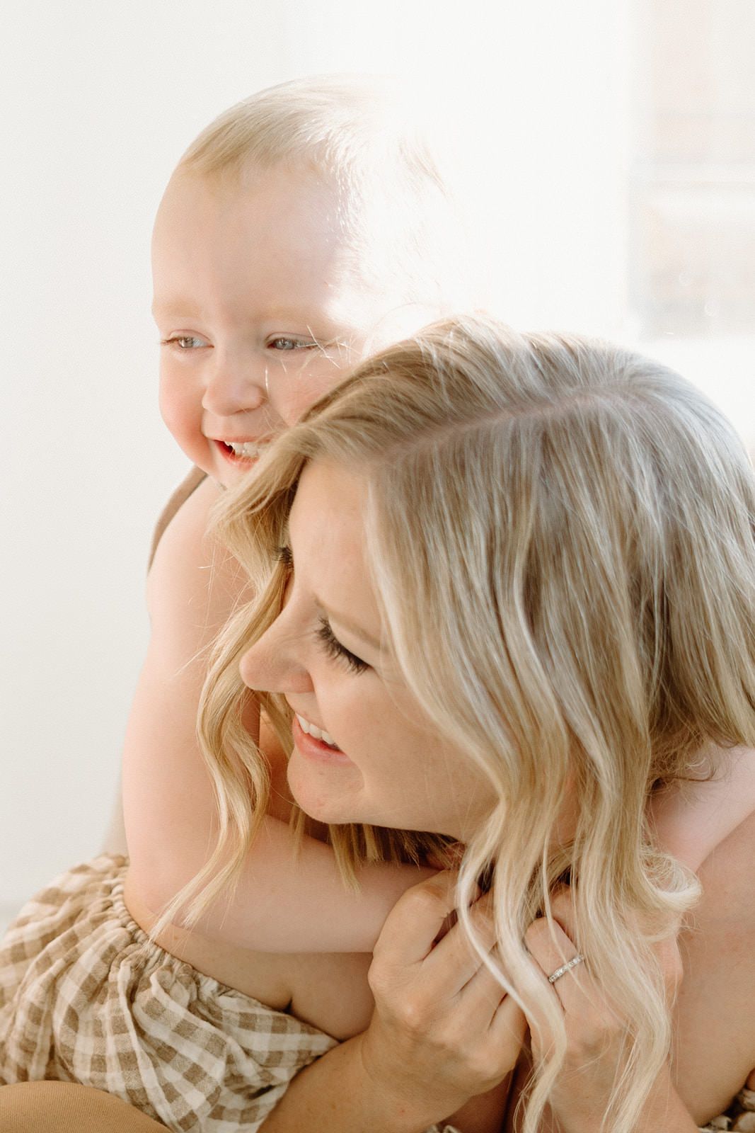 Intimate close-up portrait capturing tender family moments in soft natural light.