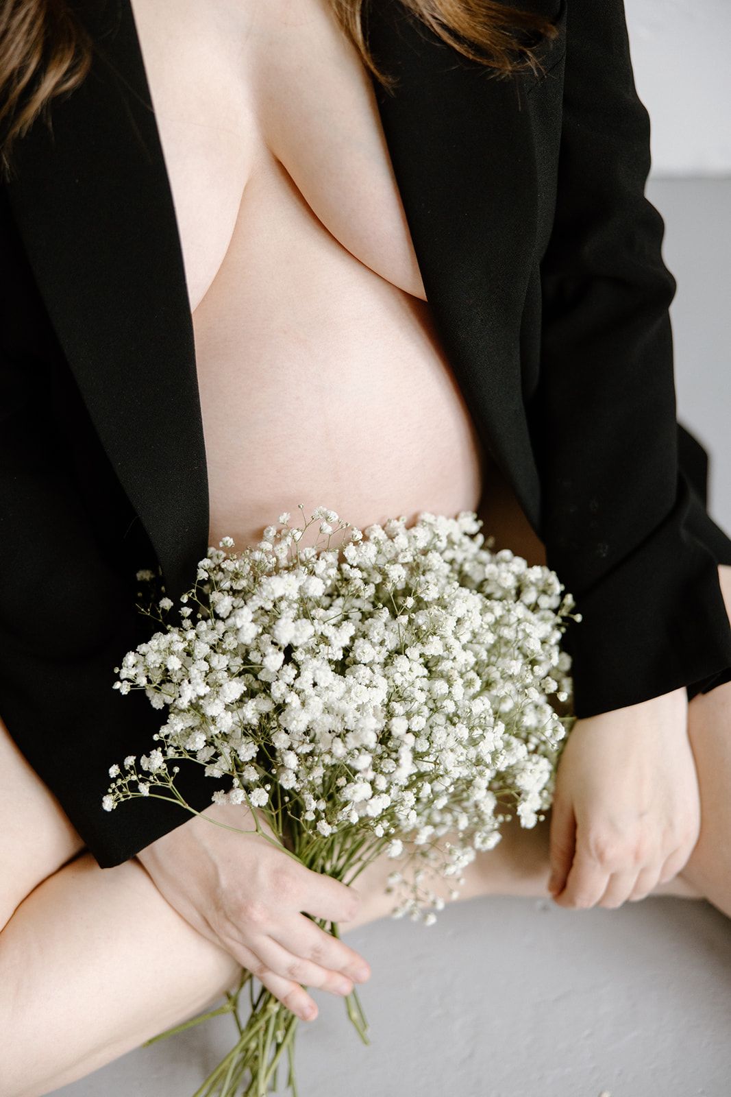A series of close-up images showing hands holding a delicate bouquet of baby's breath flowers against a white background.