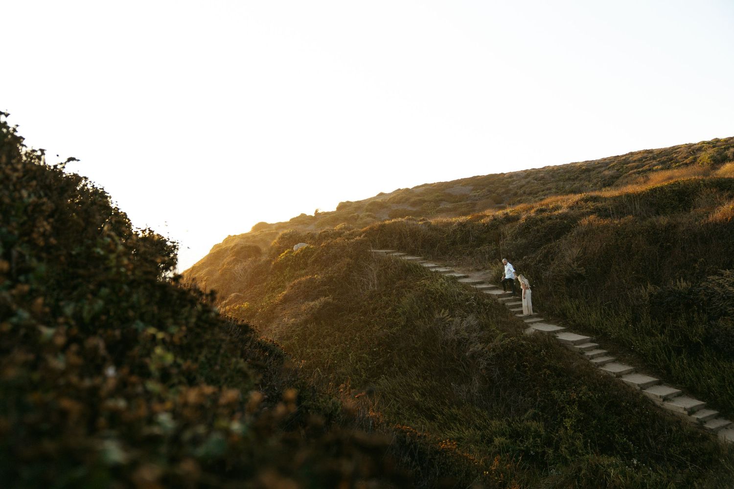 A panoramic series of dramatic mountain landscapes with winding roads traversing steep hillsides and valleys at sunset.