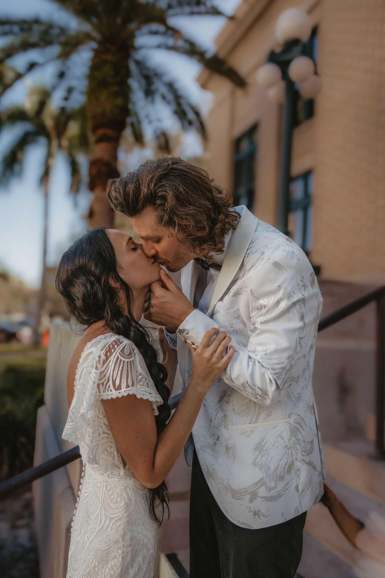 A romantic sequence showing a couple in wedding attire sharing intimate moments against a palm tree backdrop.
