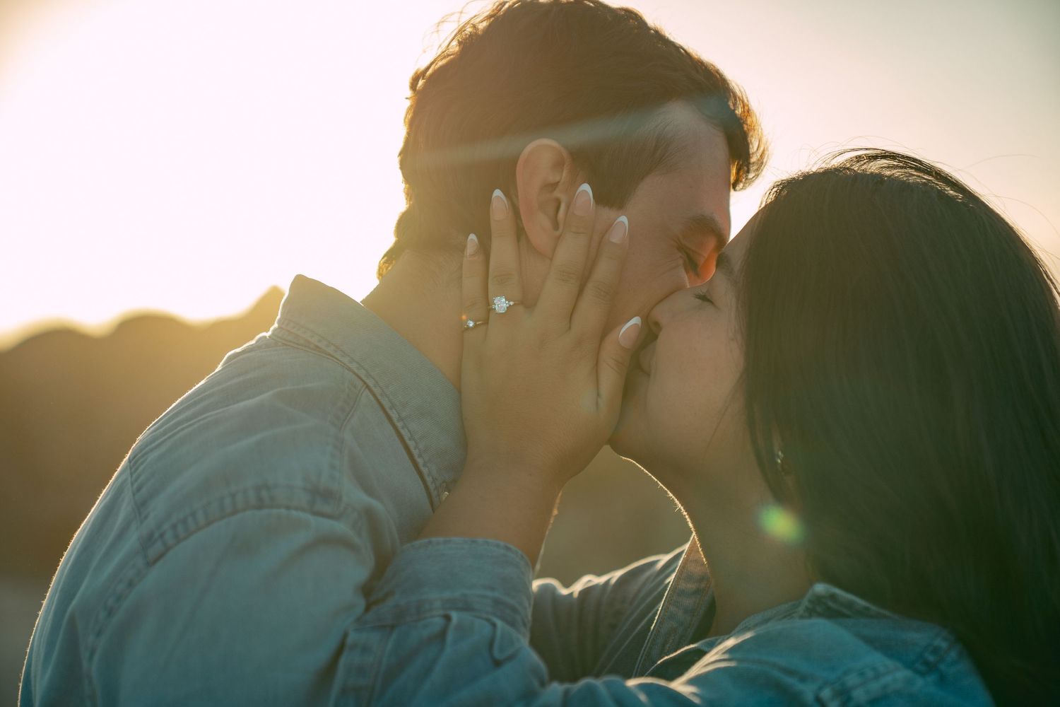 Newly engaged couple celebrating at sunset in Pacific Grove California.