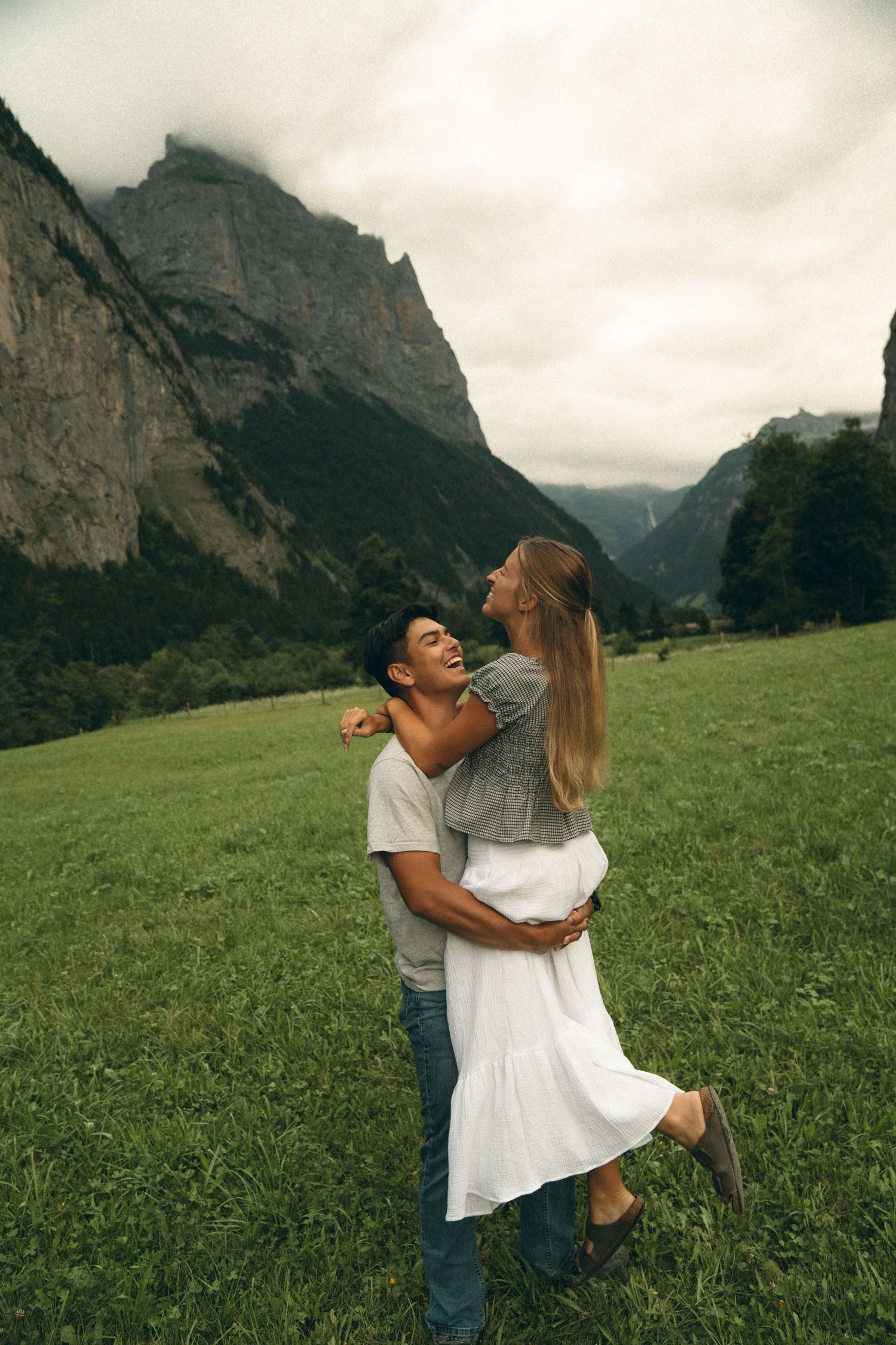 Documentary style photos of Couple frolicking through the meadows of Switzerland
