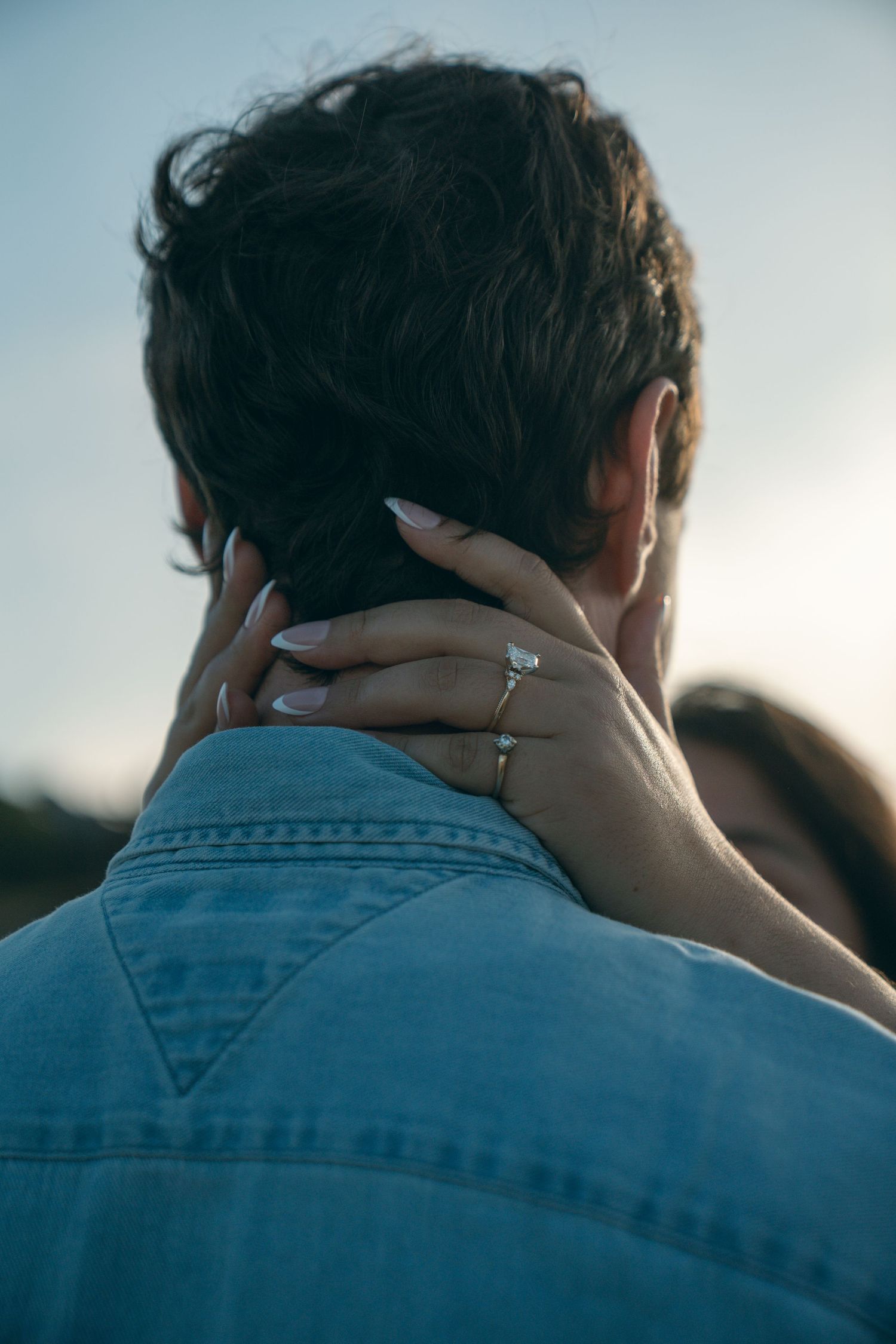 Person in denim jacket shown from behind in a series of closeup shots at sunset.