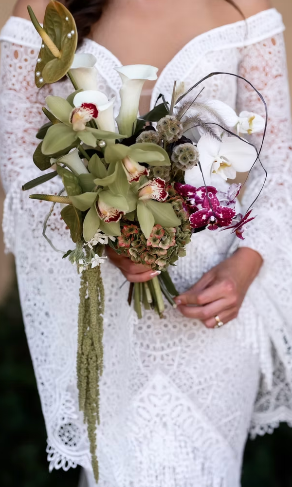 Close-up shots of a white lace wedding dress with a bouquet featuring green orchids and pink florals.