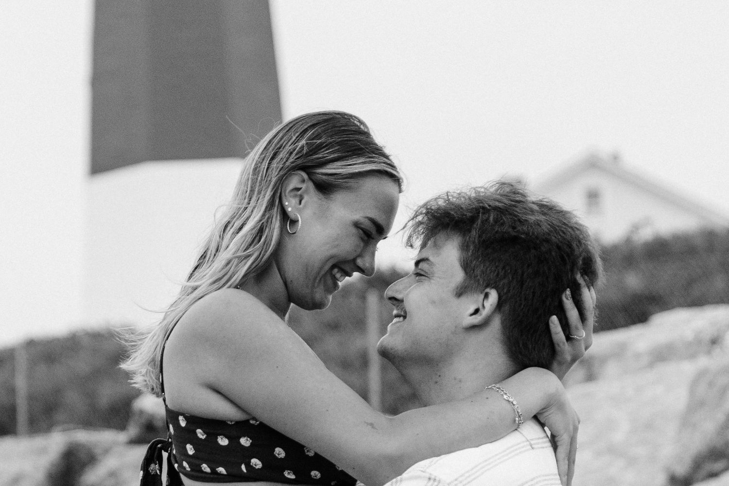 A collage of romantic black and white photos showing five close-up shots of couples kissing in intimate moments.