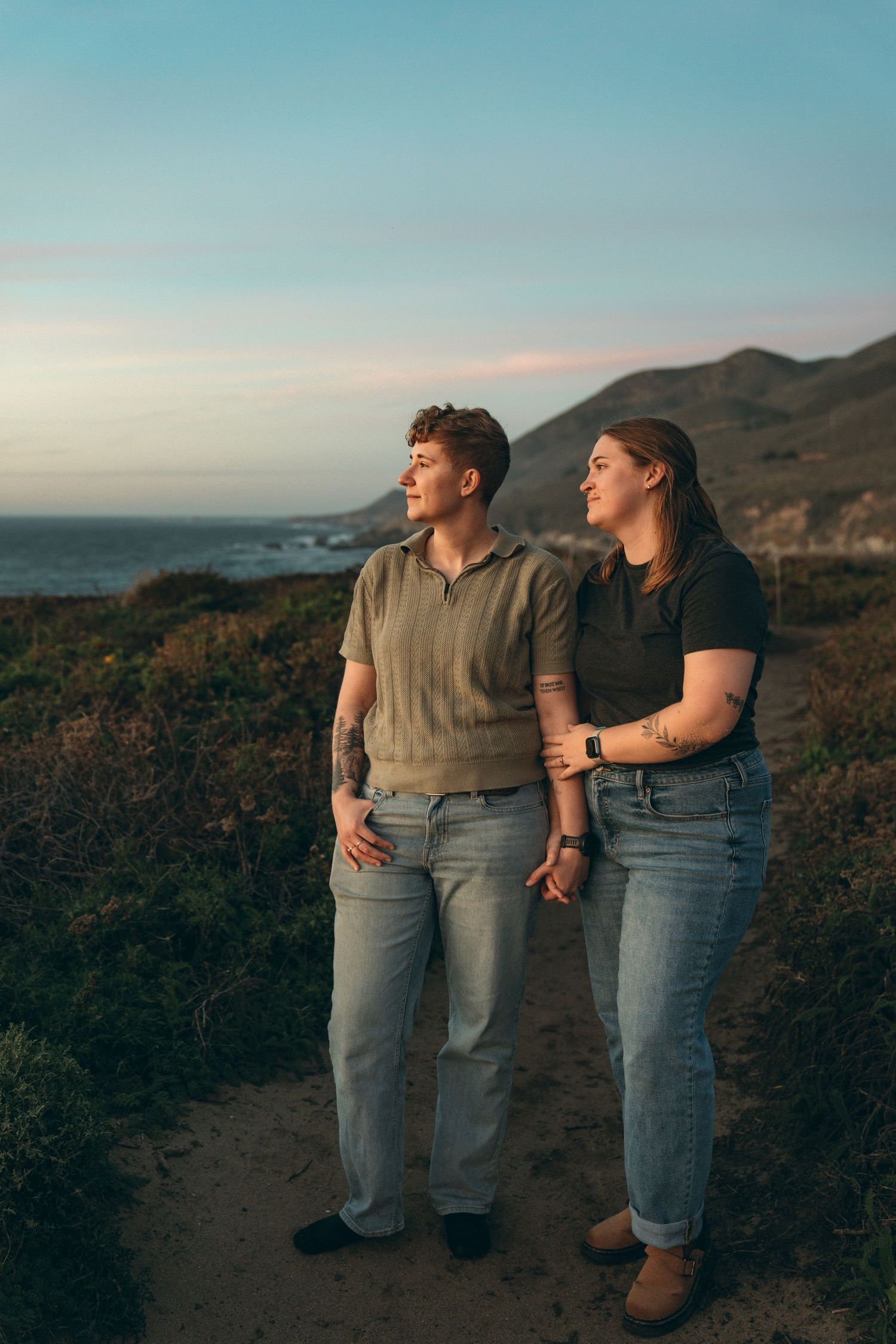 Couple watching sunset on the beaches of Big Sur.