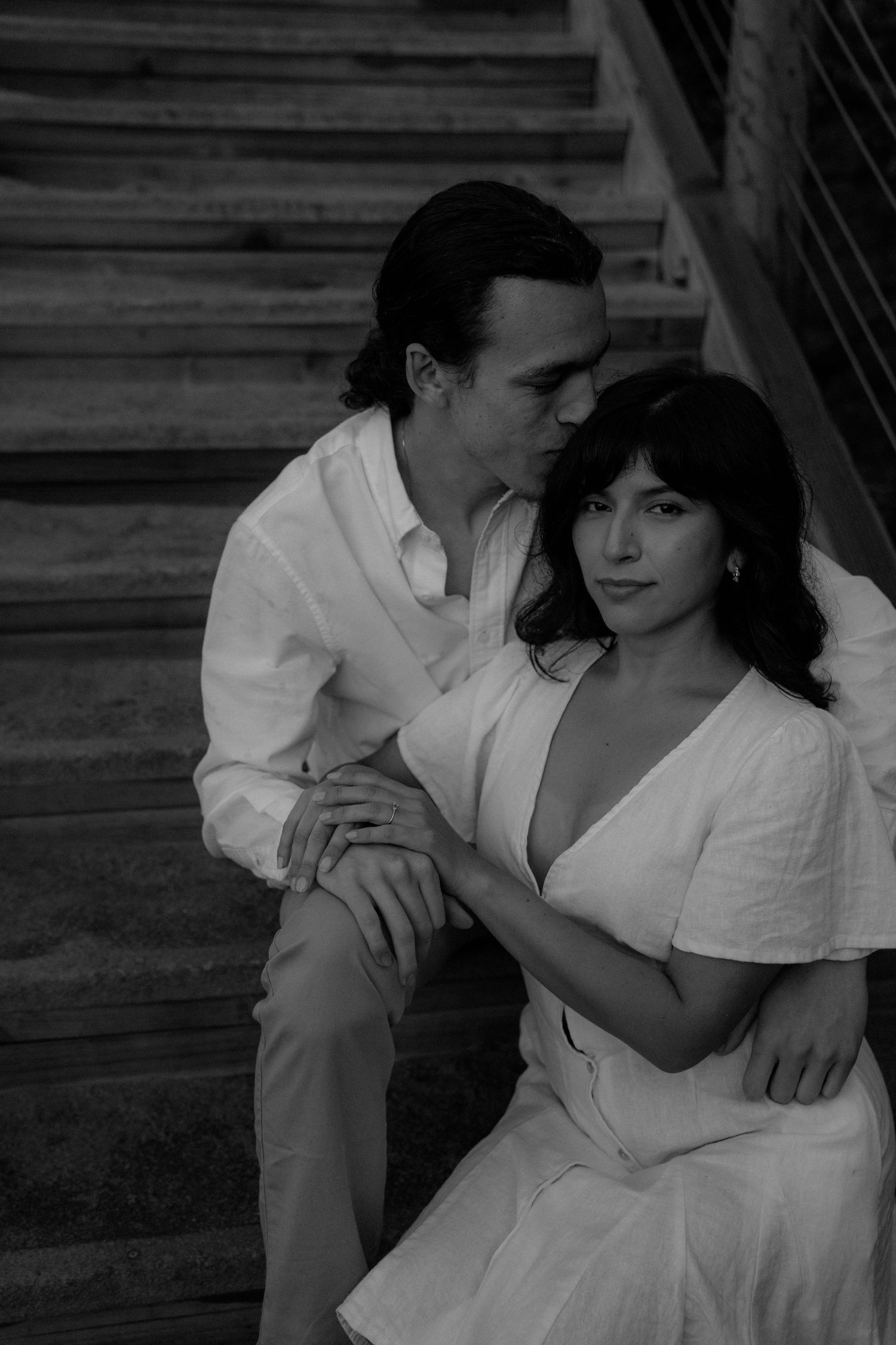 A romantic black and white photo sequence showing an intimate couple in white clothing.