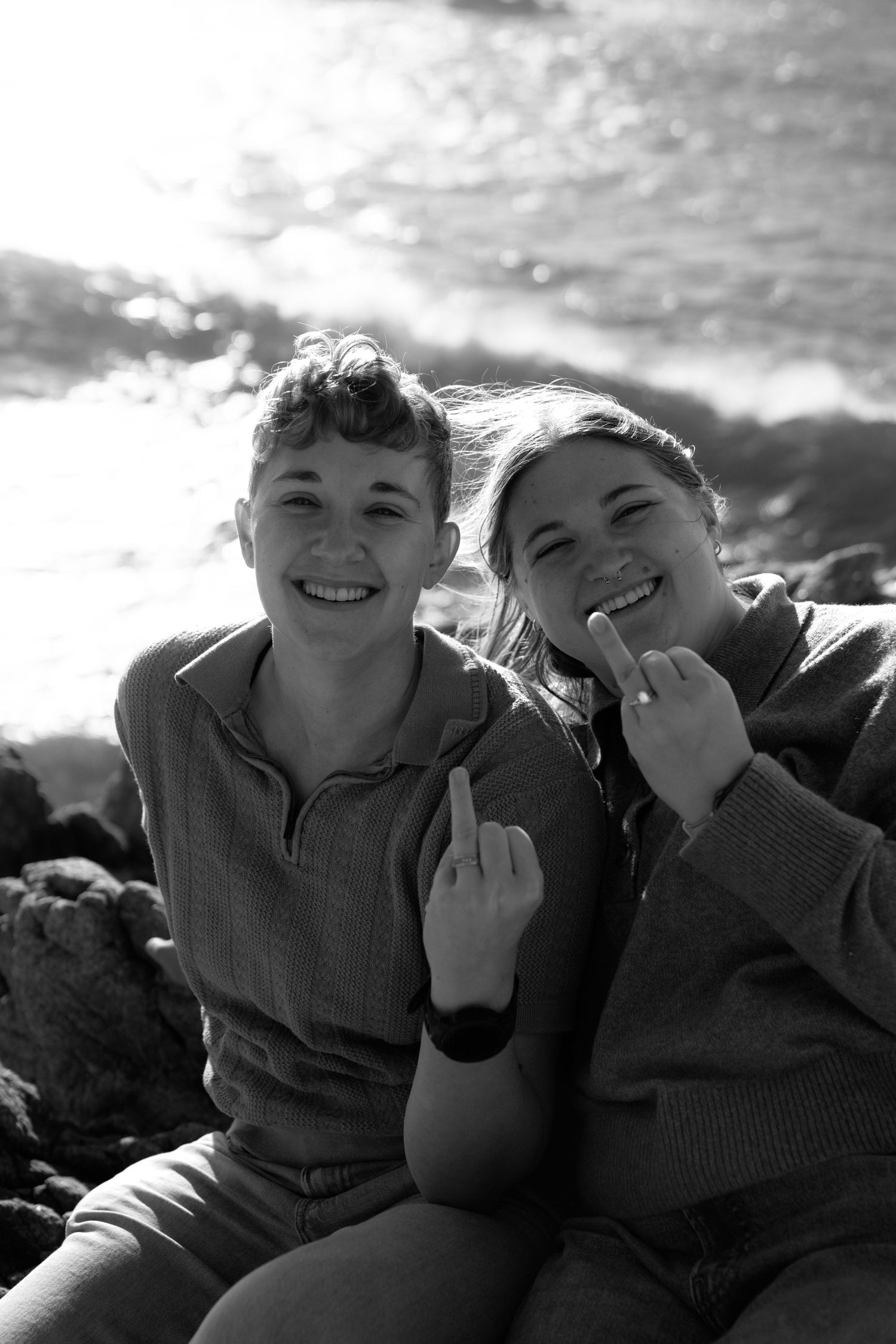 Black and white candid photos showing playful laughter and joy at the beach.