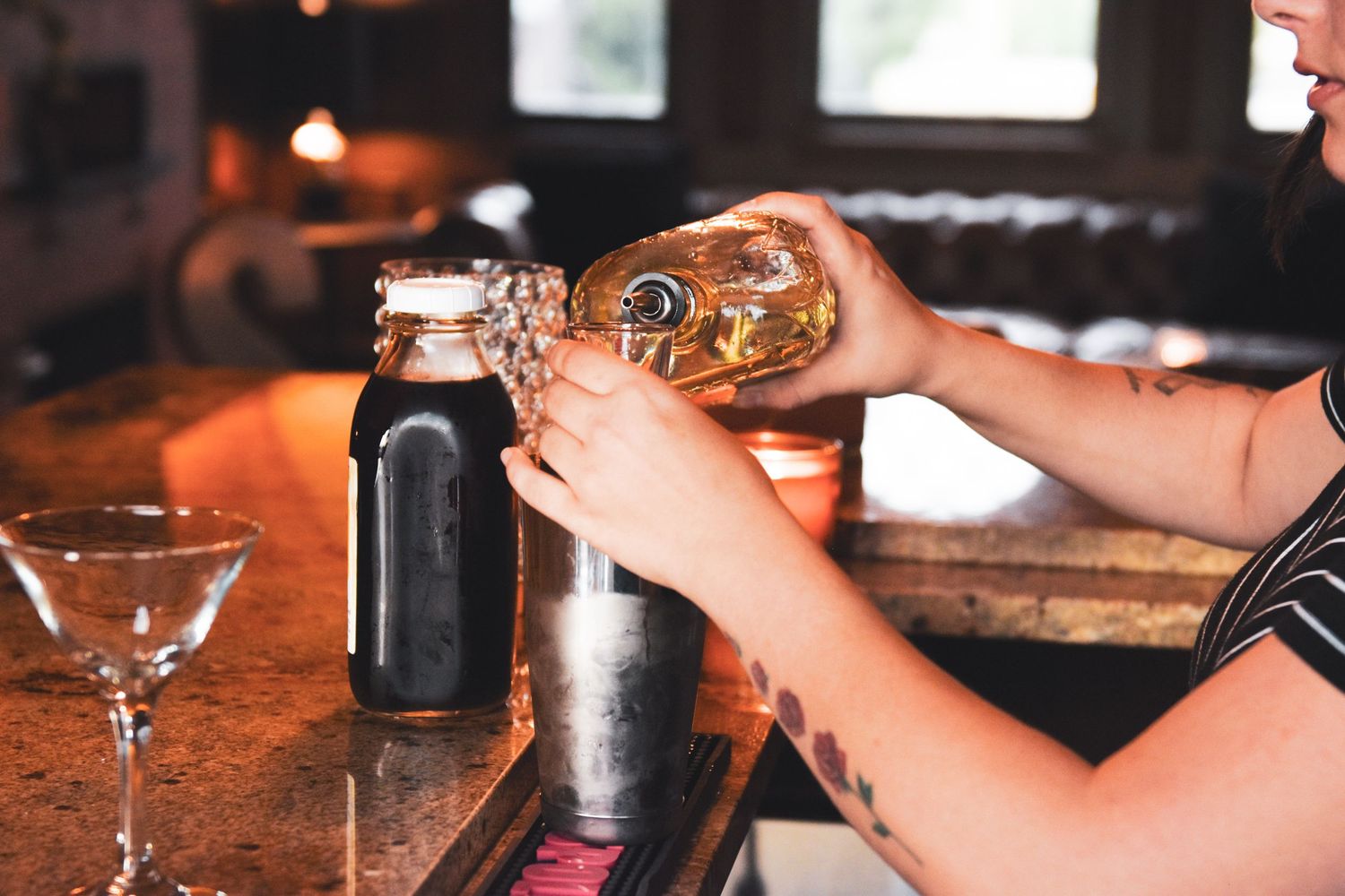 Interior photo of The Social at the Stone House, bartender making a drink at 3rd floor bar