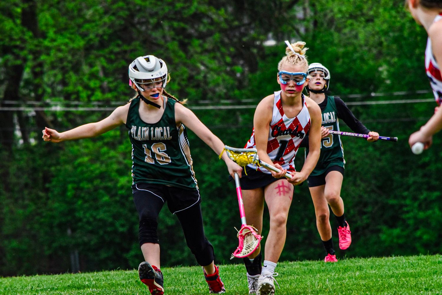 two girls play lacrosse