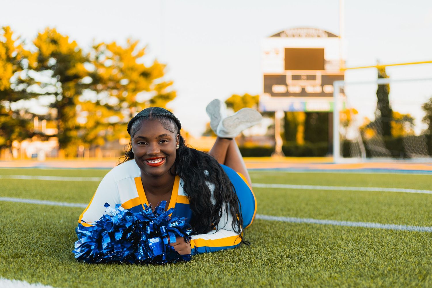 best high school senior yearbook pictures photographer Madison, WI Little Dragan Photography west regents cheerleading football field poms