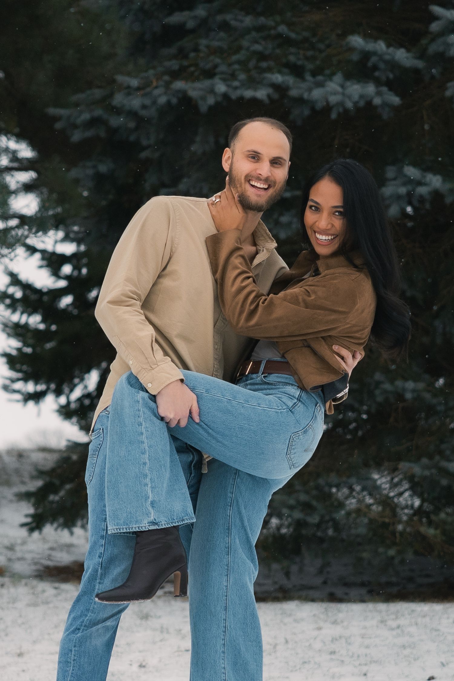 madison wi couples engagement photographer winter photoshoot snowy playing in snow outdoors proposal mcfarland waunakee verona sun prairie