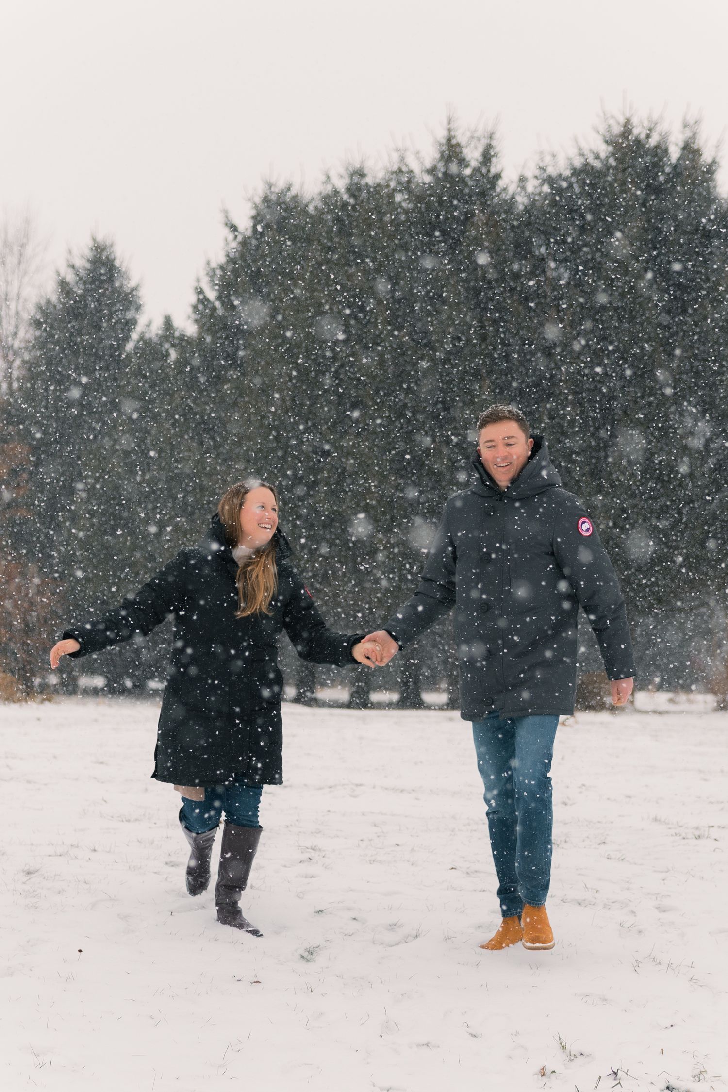 madison wi couples engagement photographer winter photoshoot snowy playing in snow outdoors proposal mcfarland waunakee verona sun prairie