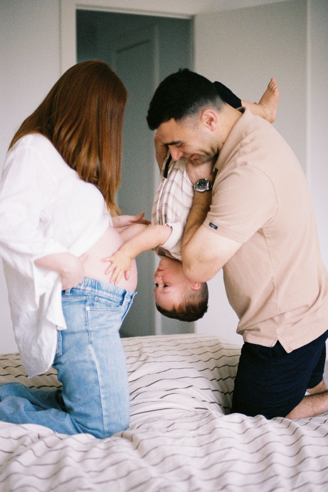 Four sequential film photos show a couple sitting on a white bed sharing intimate moments in casual attire.