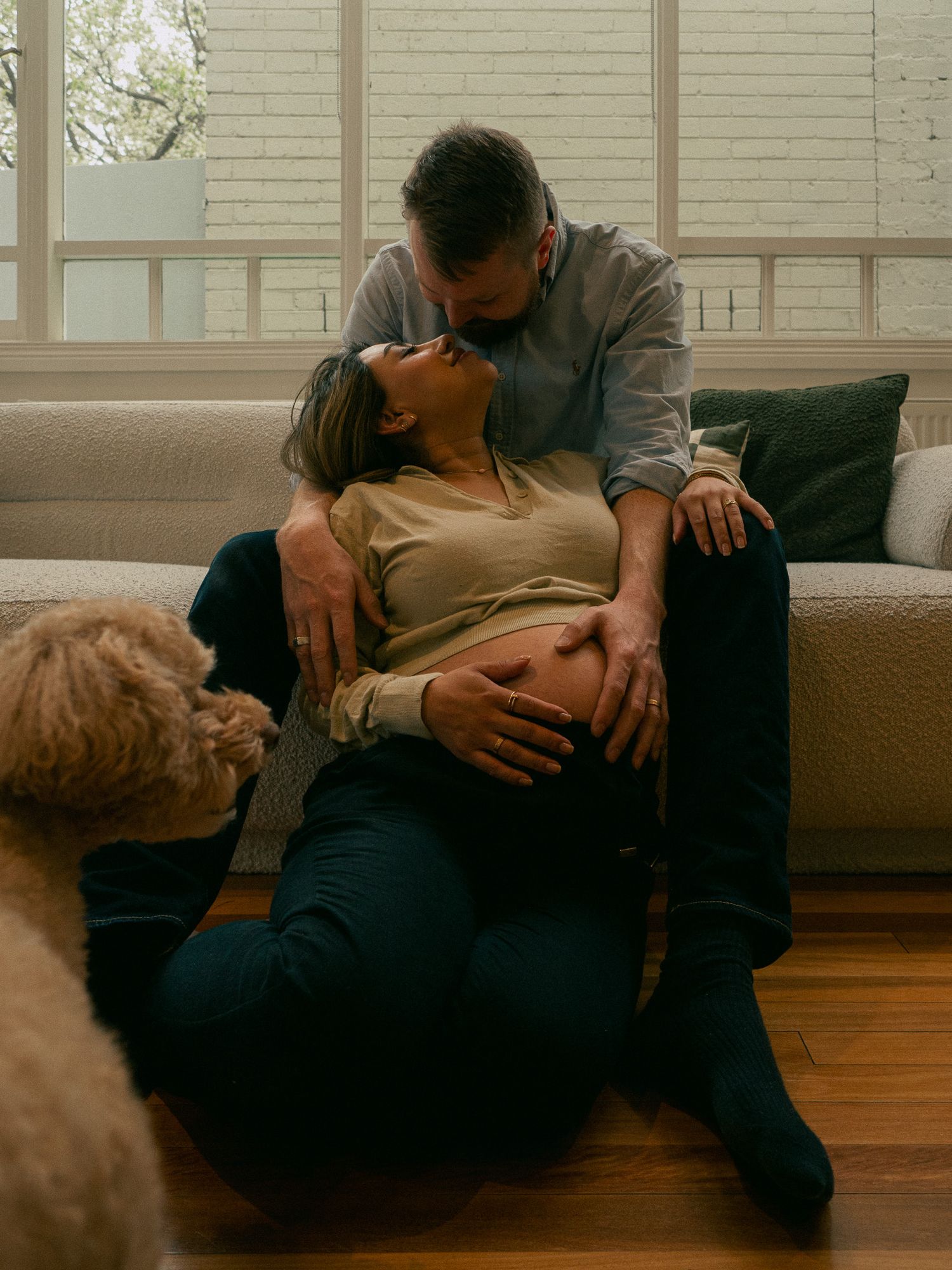 An intimate moment between a mother and father during a maternity session at their Melbourne home.