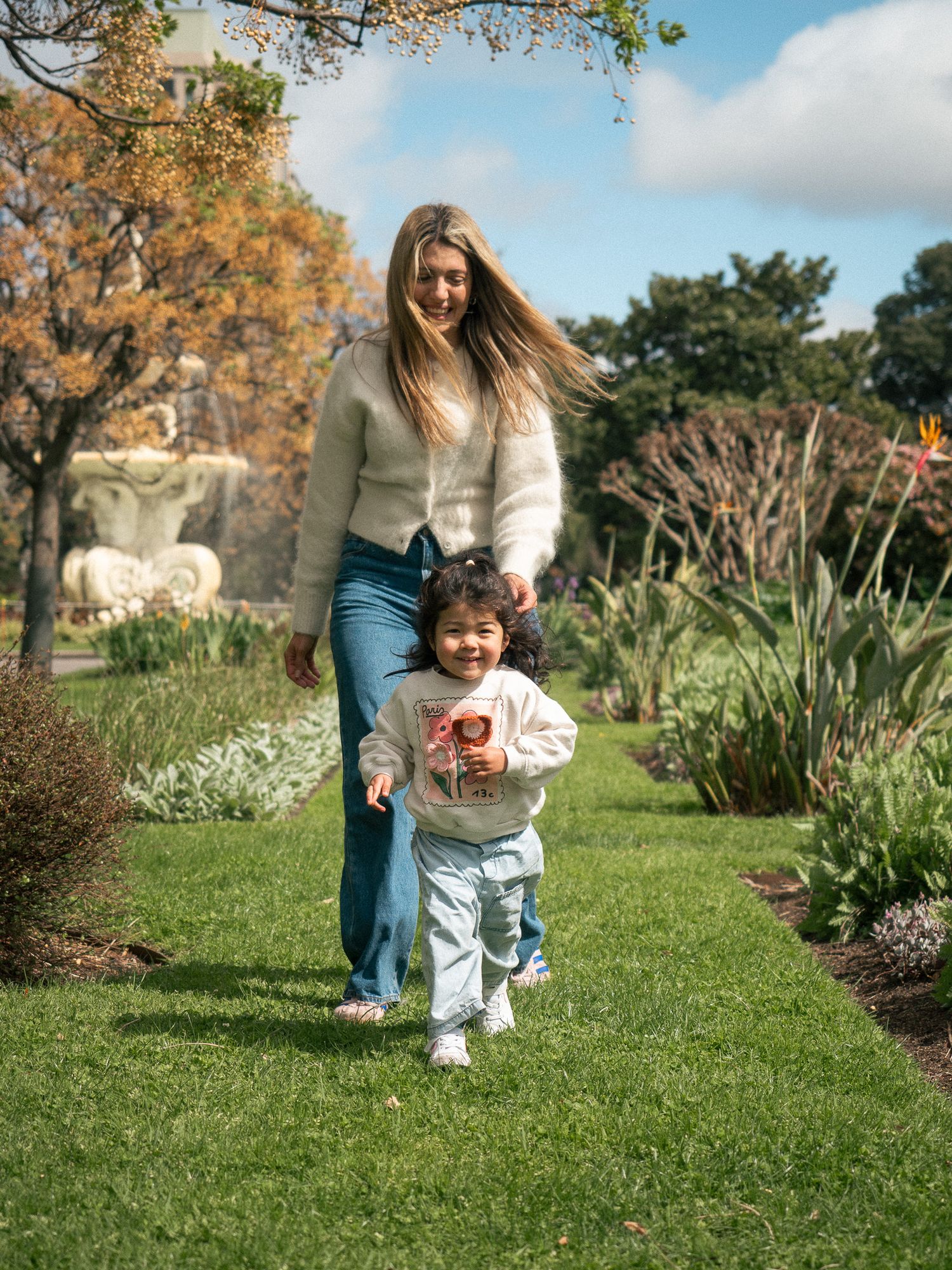 A series of candid moments captured in a garden setting with autumn foliage and greenery in the background.