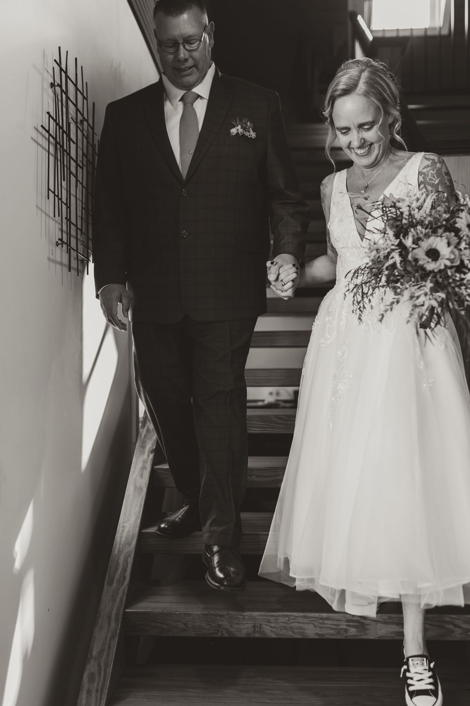 A black and white photo series captures intimate wedding moments in a rustic indoor setting.