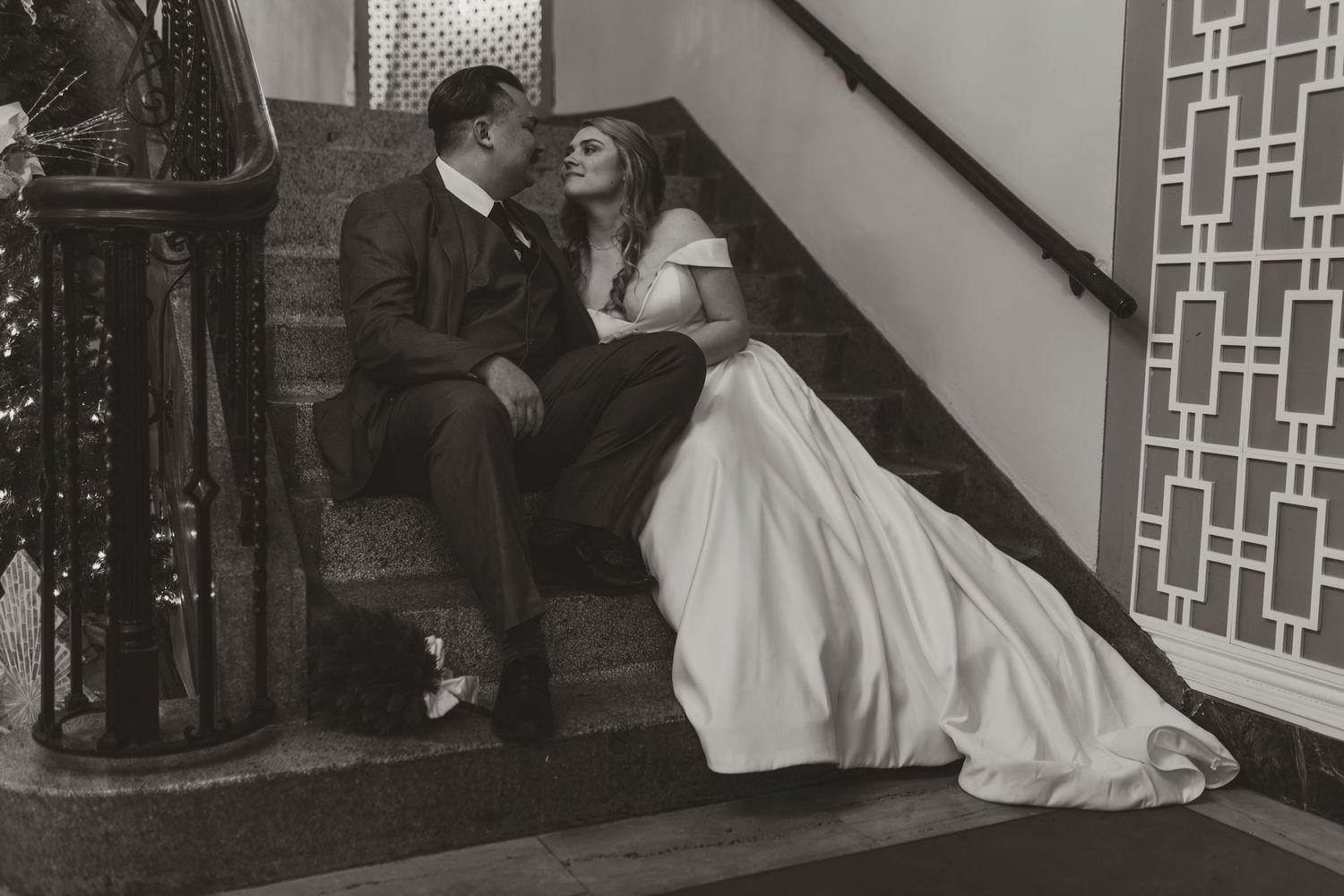 Elegant wedding ceremony setup in a historic venue with ornate geometric wall patterns and decorative details.