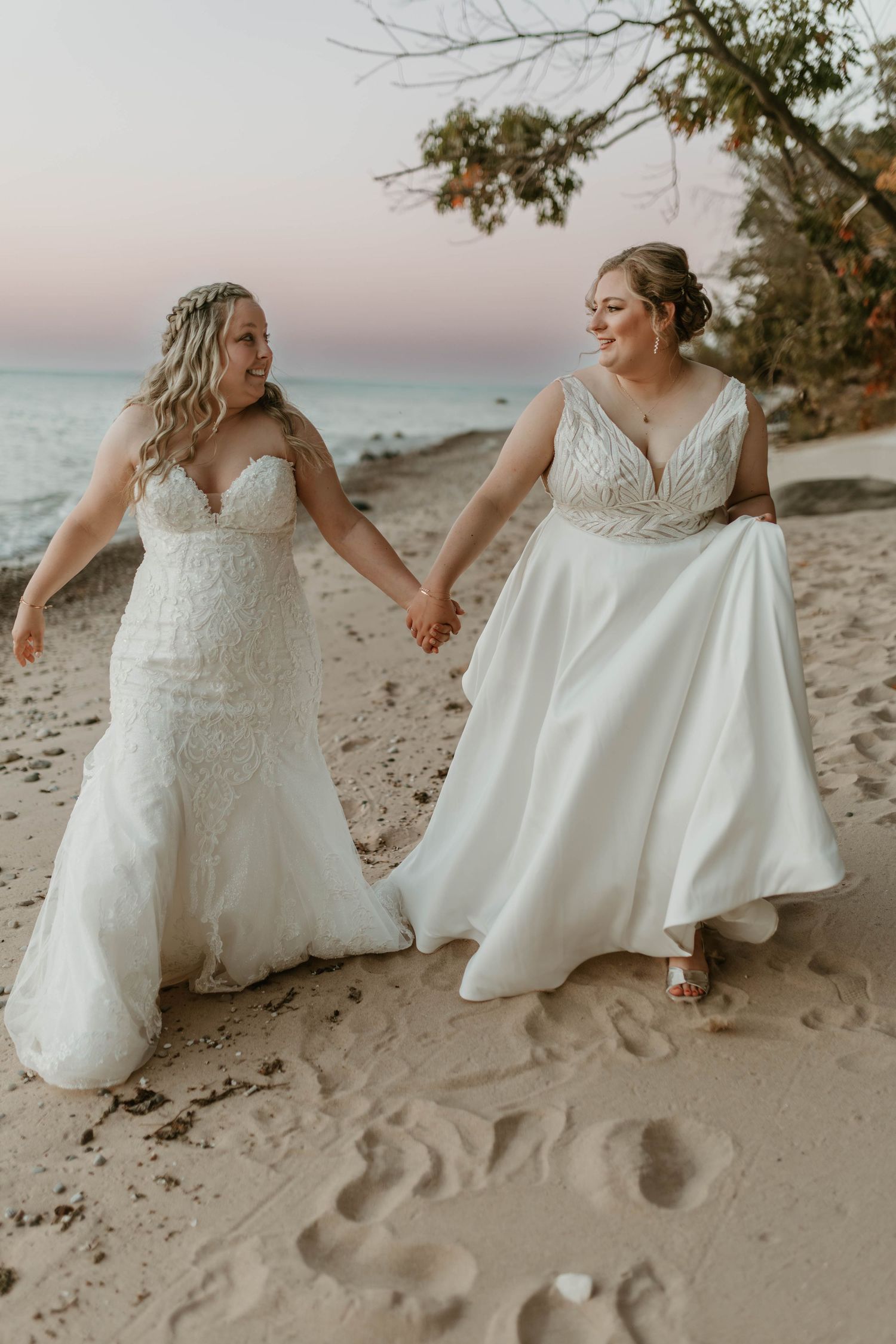Romantic beach wedding photos with white dresses against sandy shoreline at sunset.