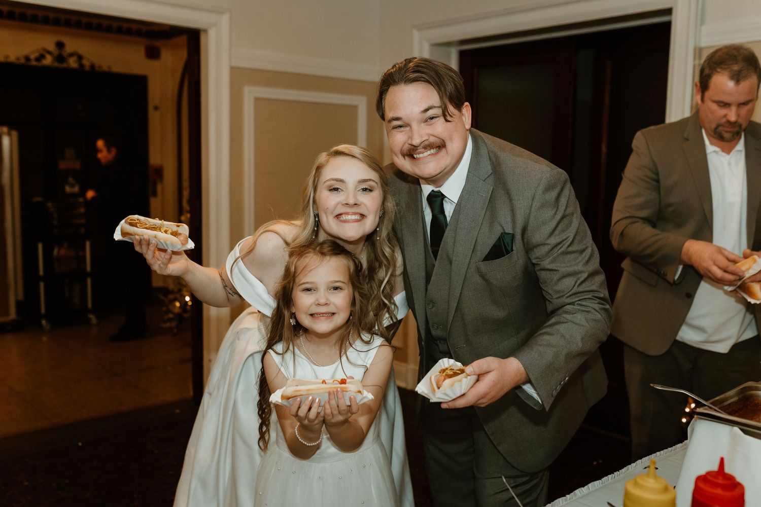 Wedding reception candid moments with guests enjoying food and laughter.
