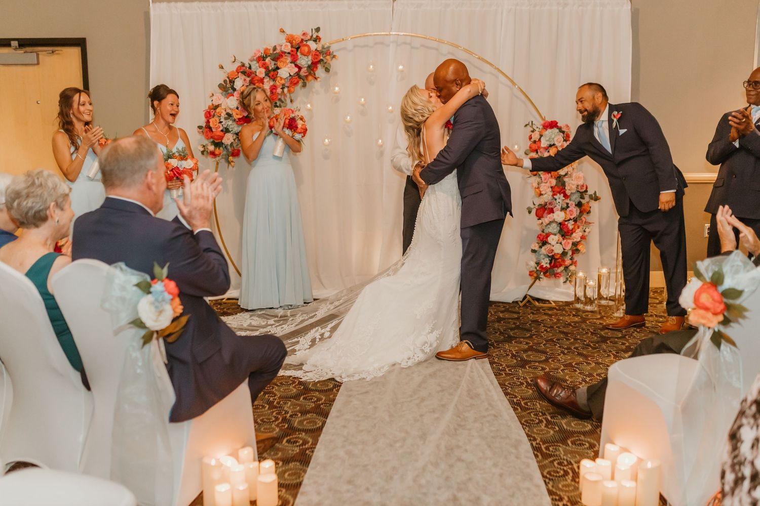 Wedding celebration sequence with coral floral decor and romantic lighting in an indoor venue.