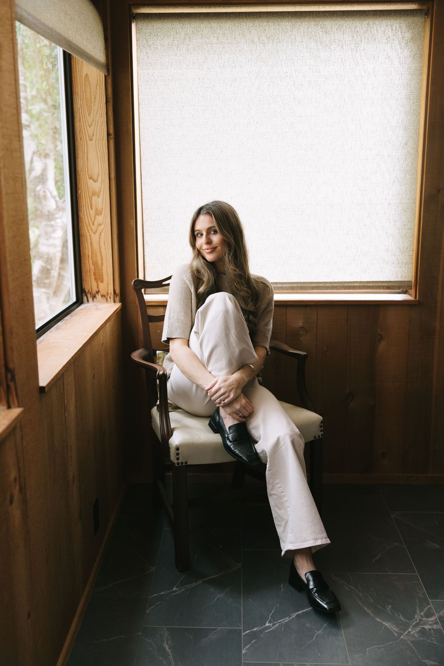Artistic portrait series showing someone in white clothing seated by windows in a wooden room.