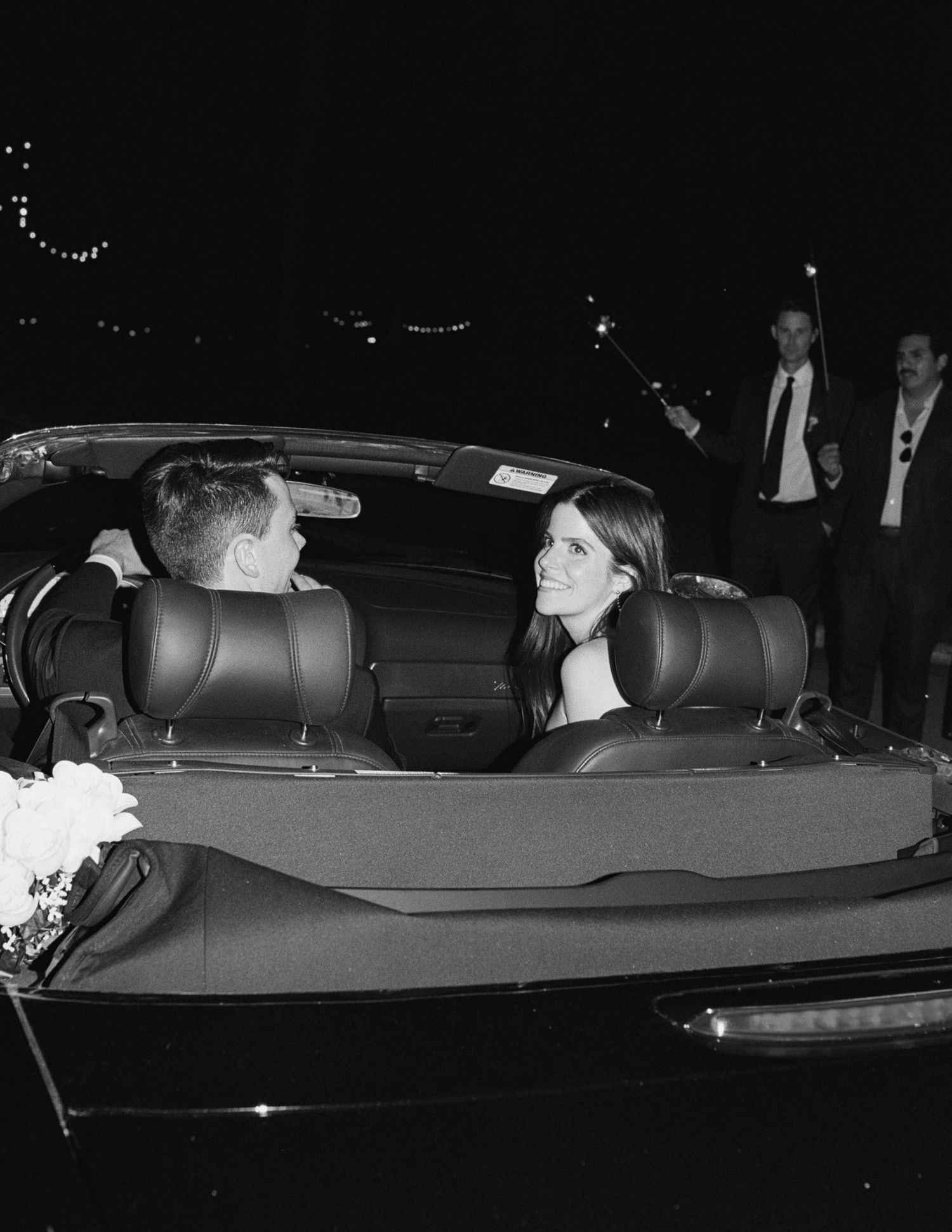 Side view of a decorated wedding car ready for departure in the evening.