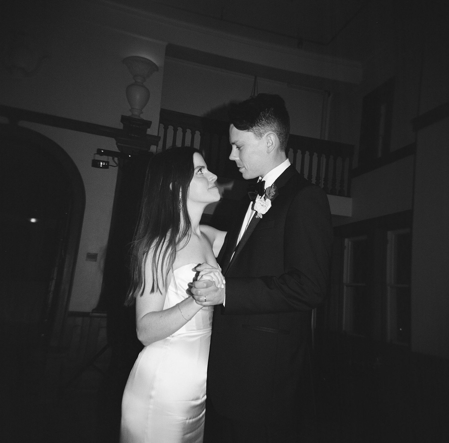 A couple sharing a romantic dance moment in black and white photography.