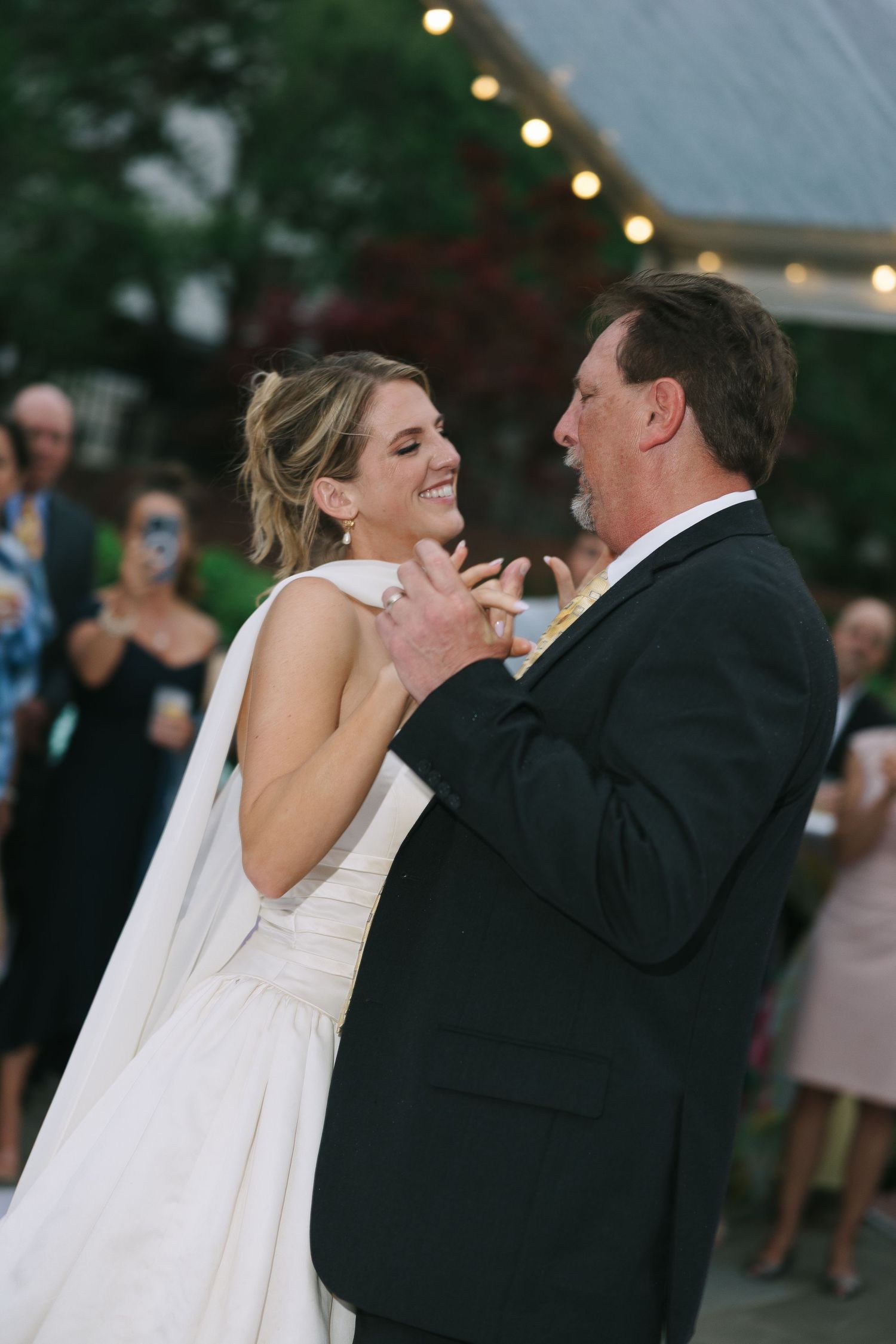 A couple shares an intimate dance moment during their wedding reception.