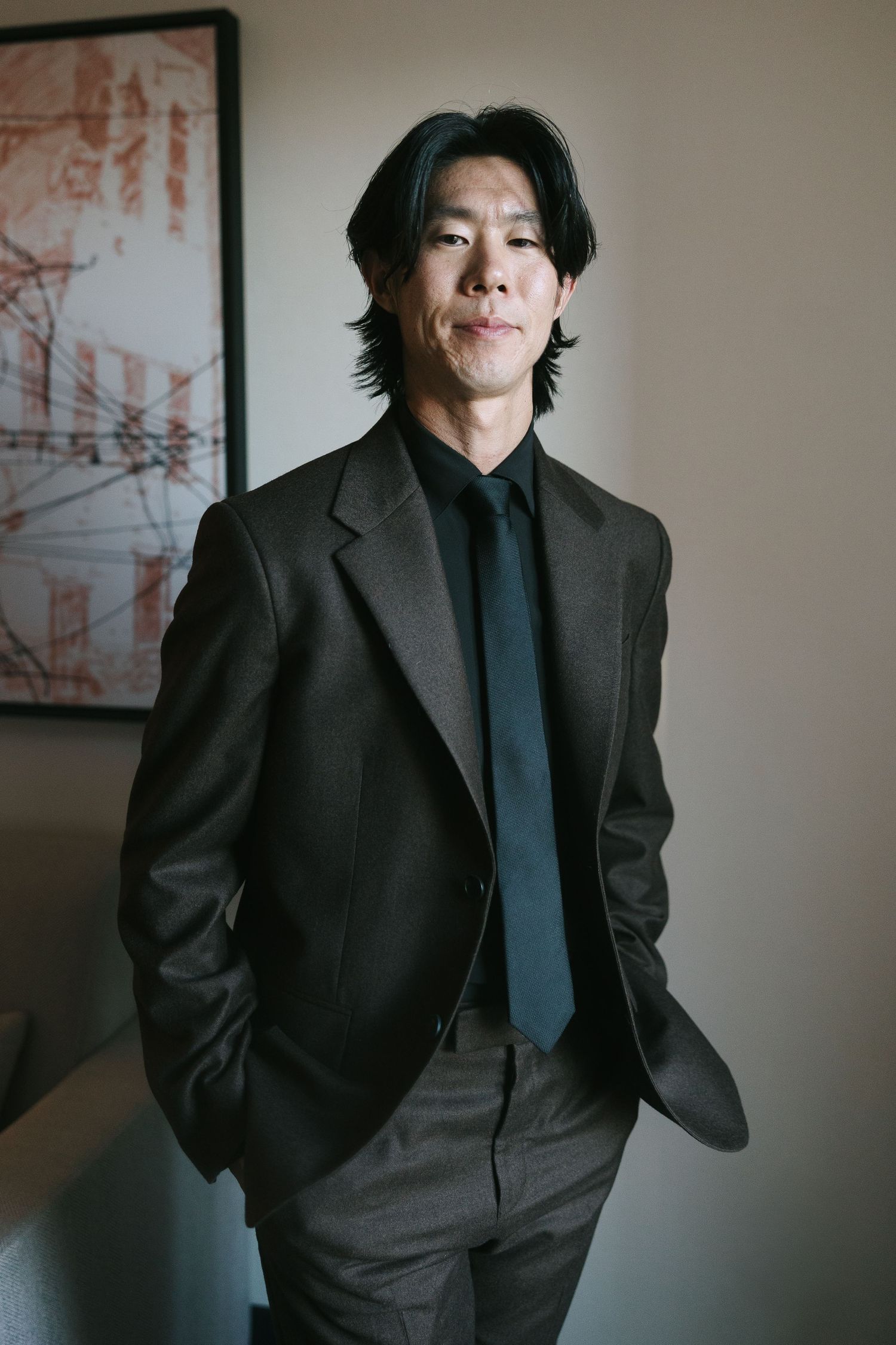 Professional portrait session in formal black suit and tie.