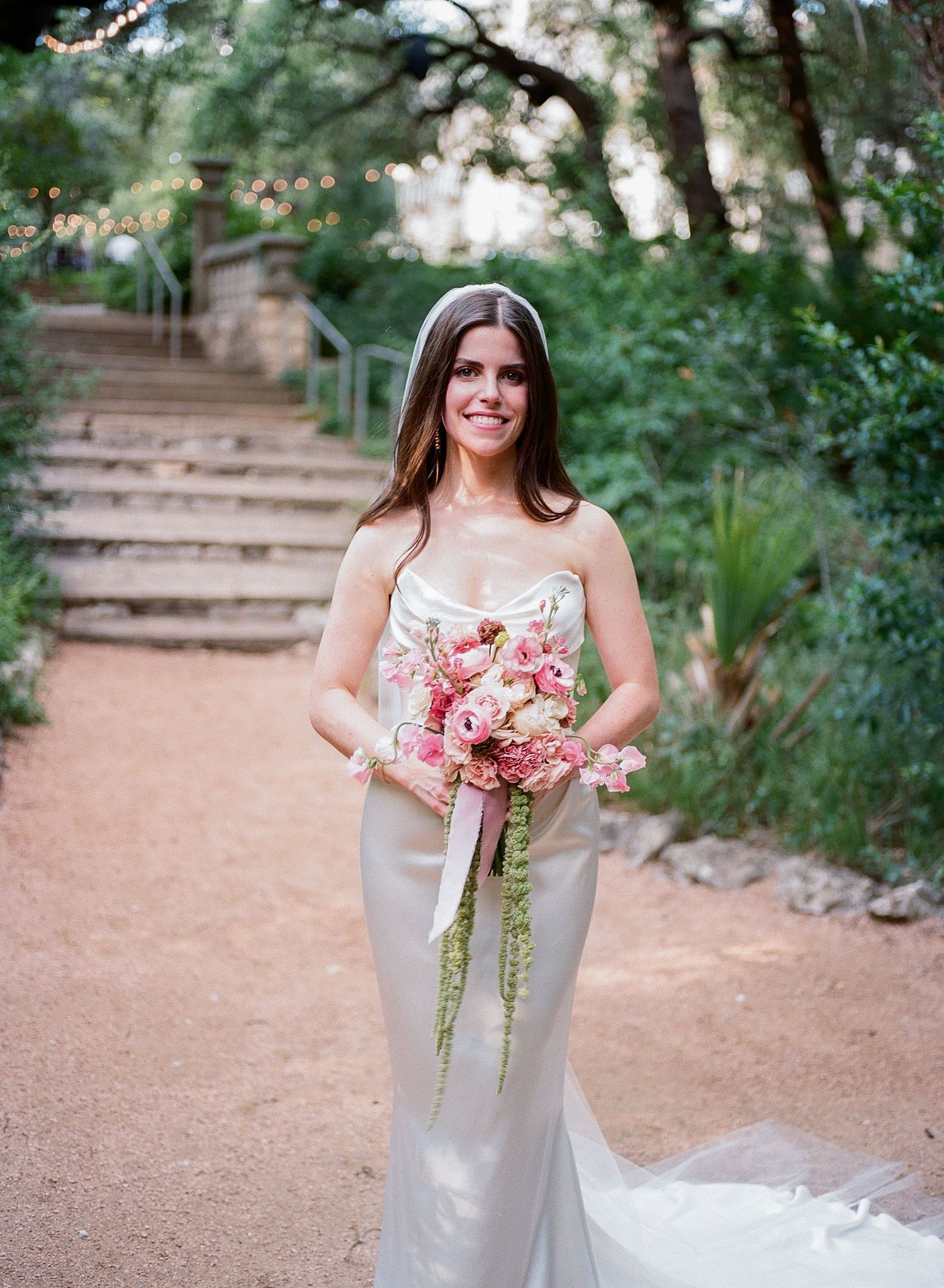 A wedding photo series featuring a white dress and pink bouquet against stone steps and greenery.