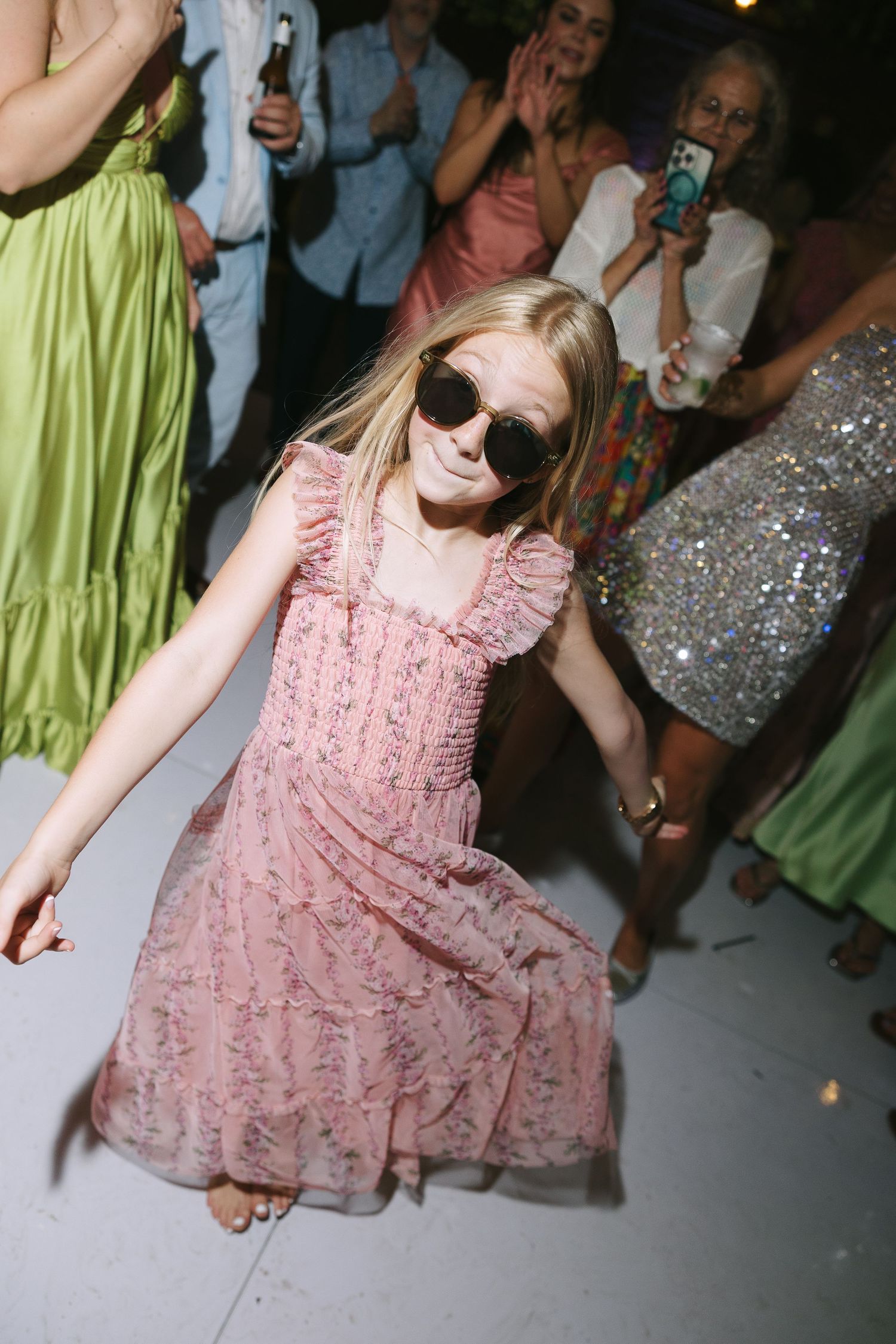 Person in pink dress dancing at a wedding reception.