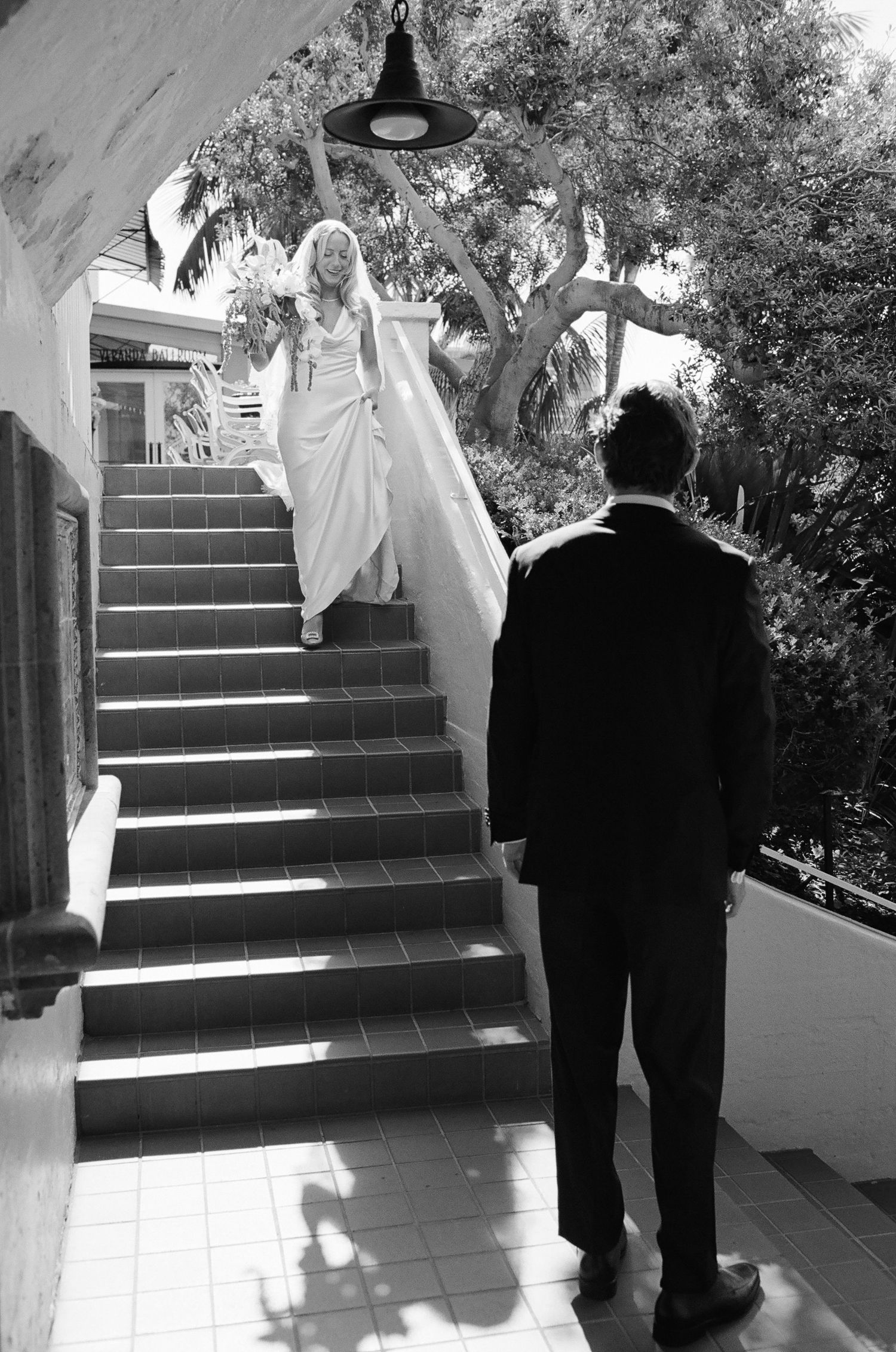 People ascending outdoor tiled stairs at an elegant venue.