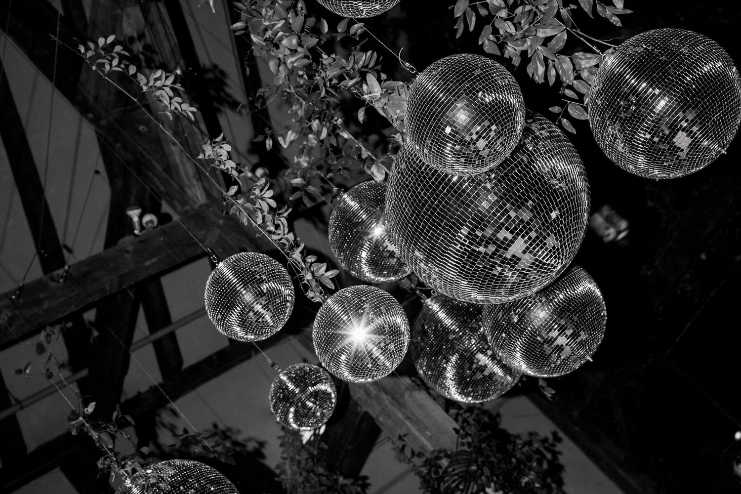 Abstract black and white pattern of hanging crystal chandeliers creating a dramatic lighting effect.
