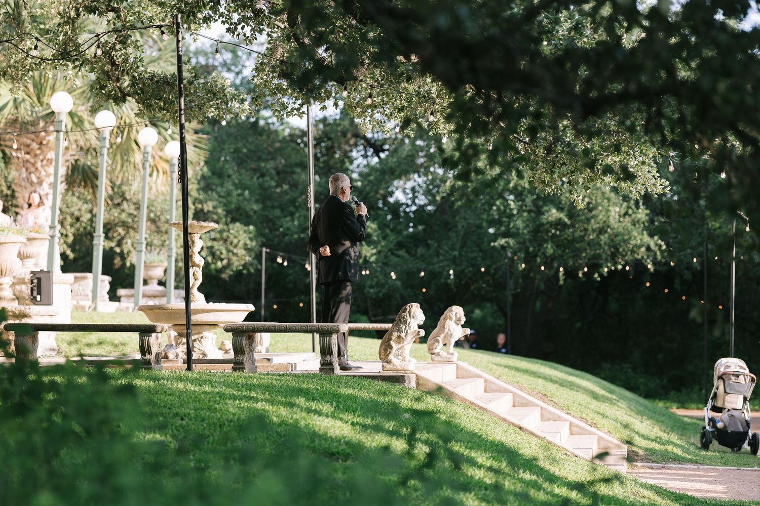 Panoramic view of a garden wedding venue with manicured lawns and mature trees.