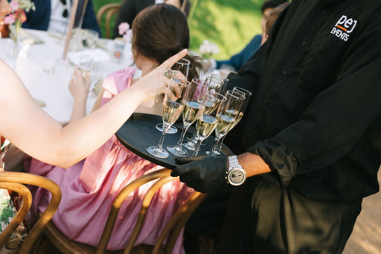 Guests enjoying drinks and conversation at an outdoor social gathering.