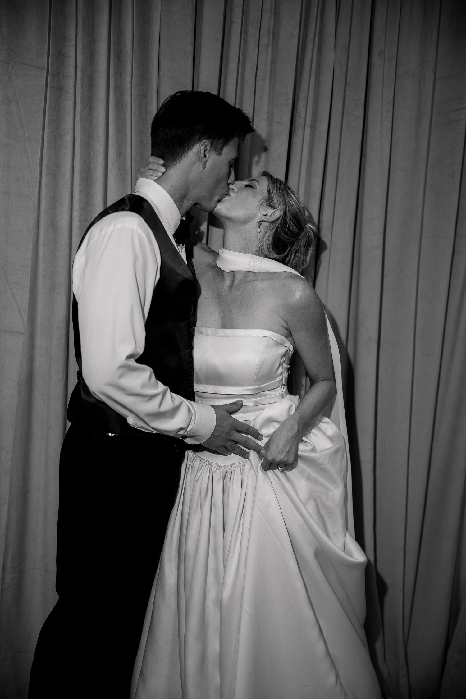 Black and white photo of couples slow dancing at a formal event.