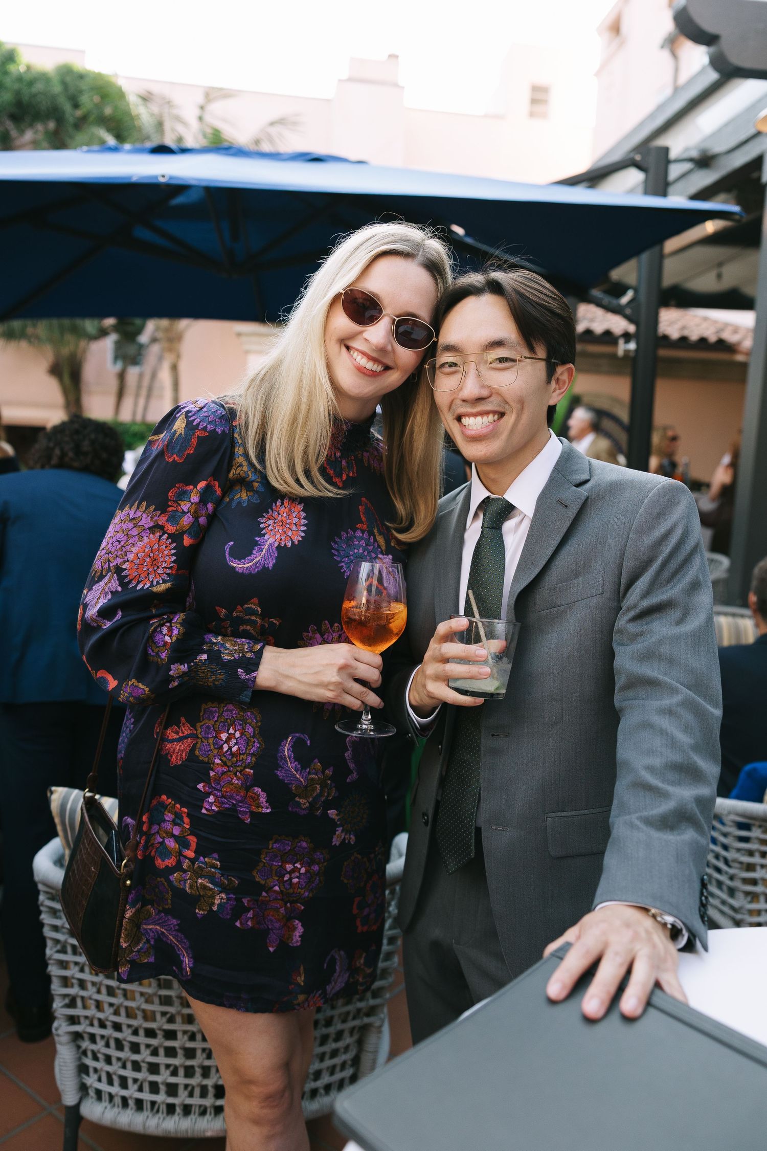 Guests enjoying drinks and conversation at an outdoor reception area.